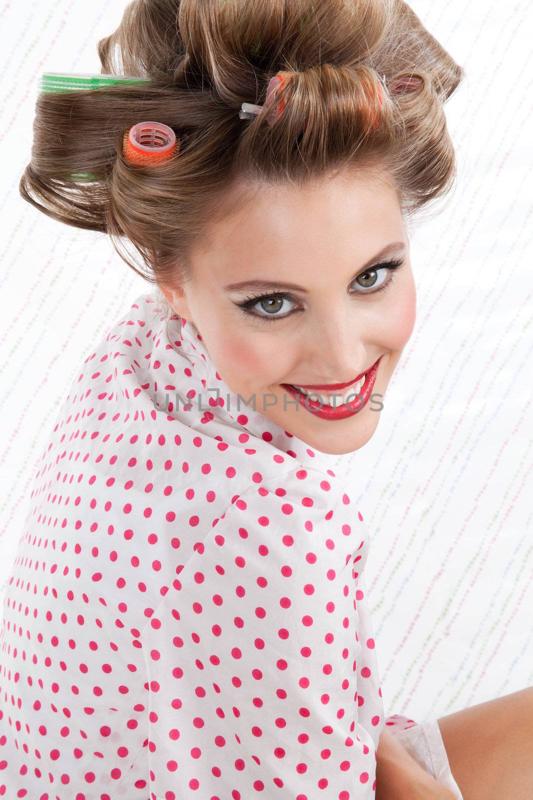 Portrait of beautiful retro styled woman with hair rollers