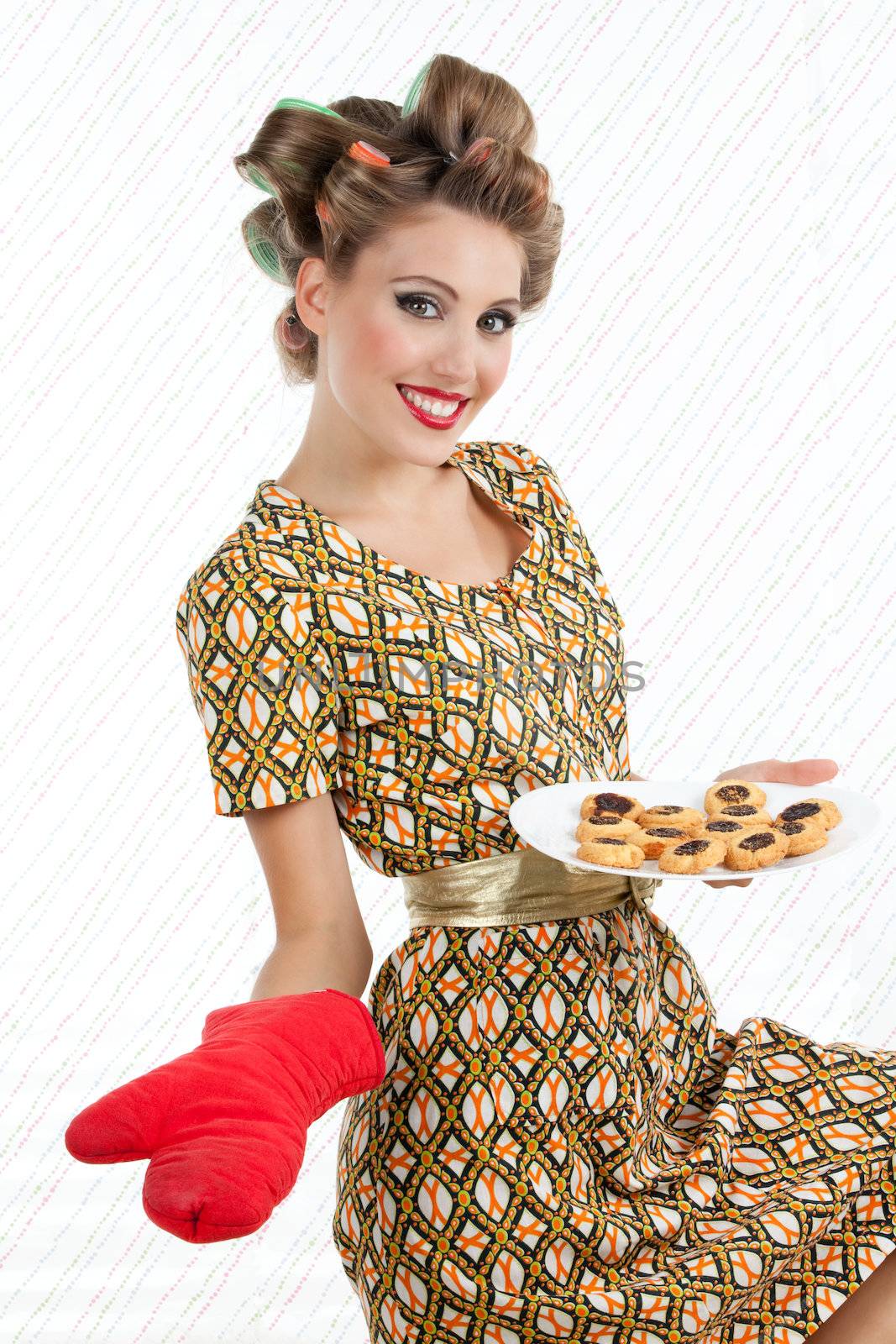 Retro woman with cookies looking at camera with smile.