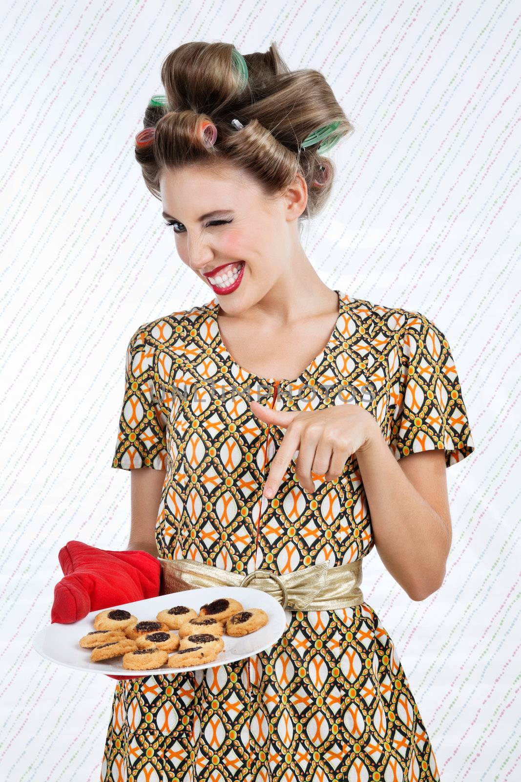 Woman Winks As She Holds Plate Of Cookies by leaf