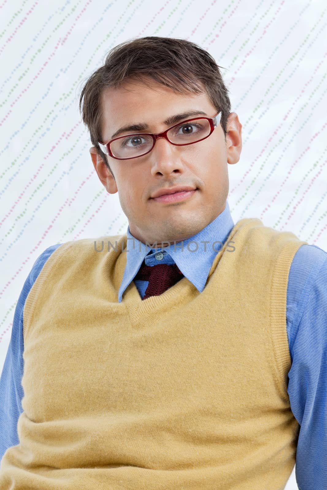 Portrait of smart young male business executive wearing eyeglasses over textured background