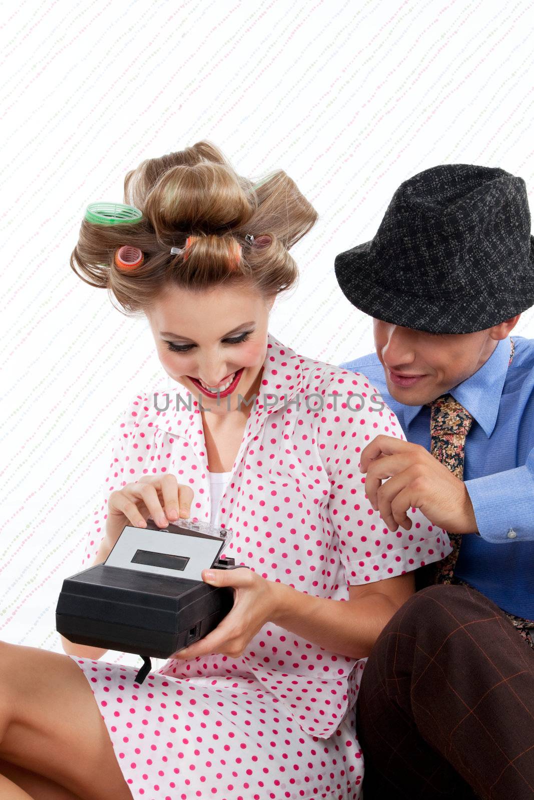 Portrait of young couple holding tape reorder.