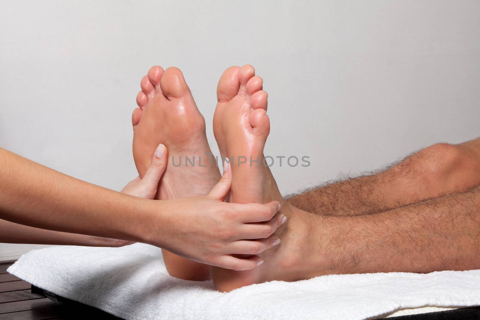 Man receiving a foot massage in spa.