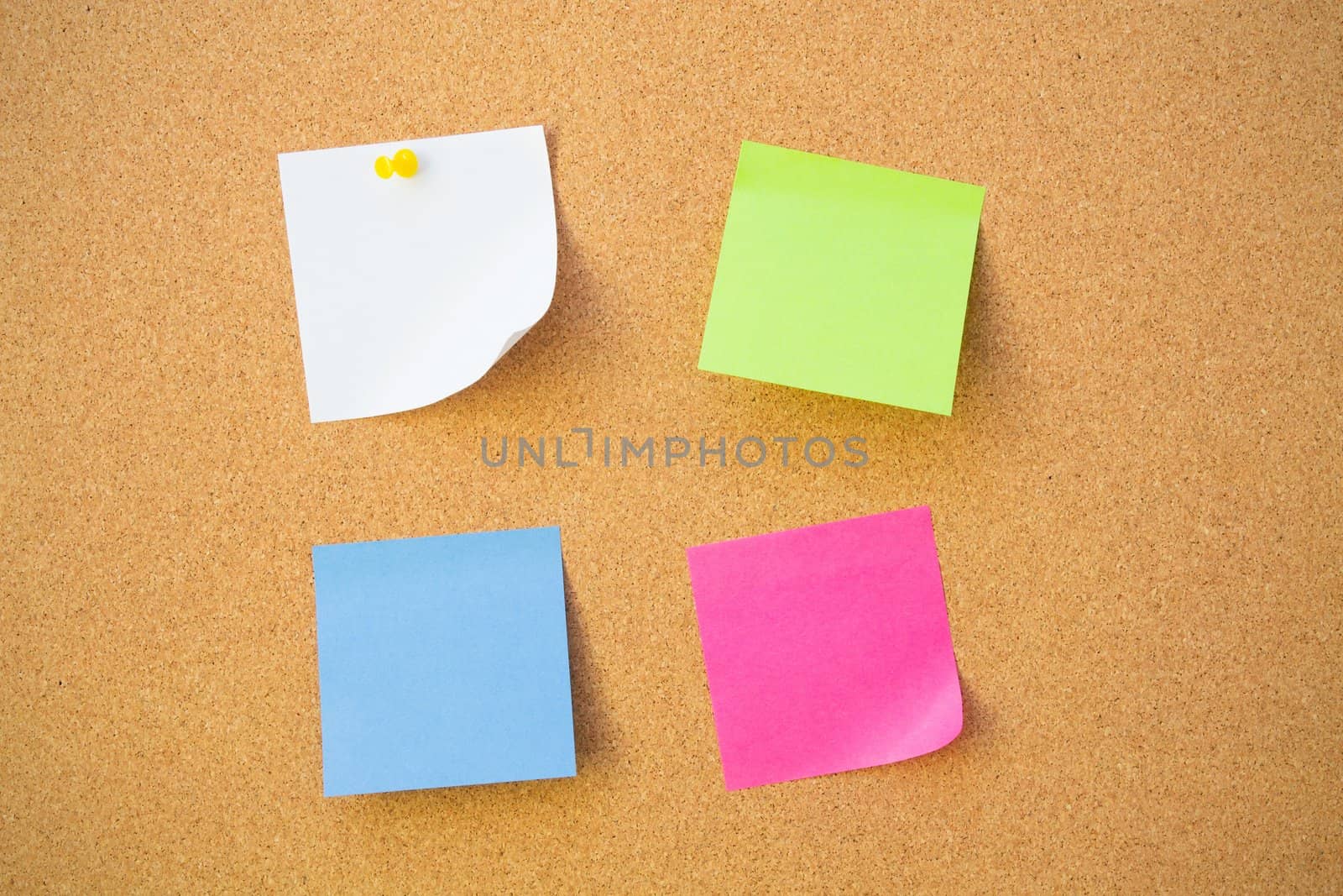 Colour note papers on pin board. Cork background  by simpson33