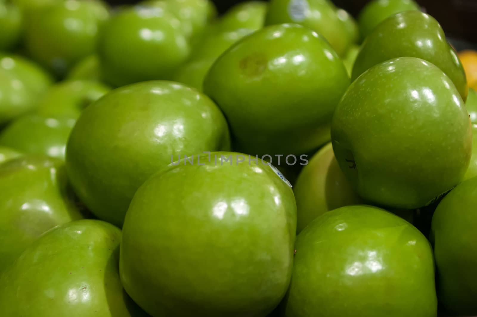 green apples on display at farmers market