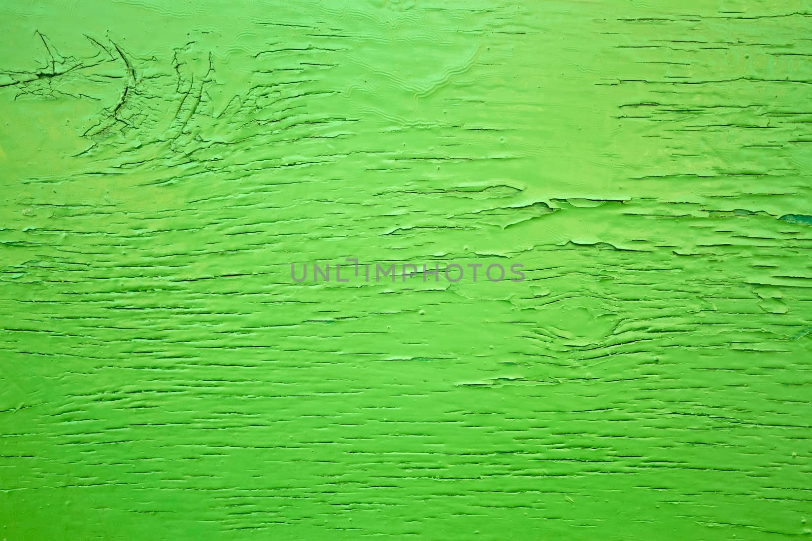 Detail of old wooden boards painted in green with several layers of shelled paint