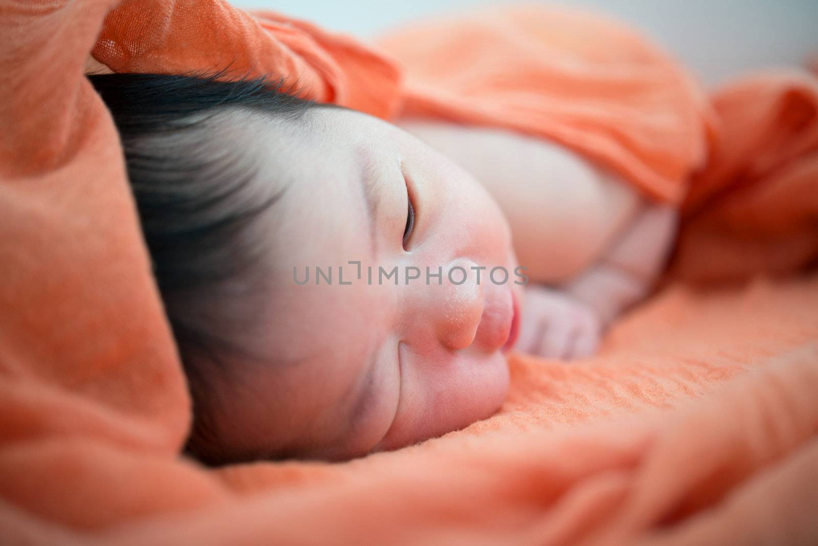 Newborn Asian baby girl on bed, 7 days after birth
