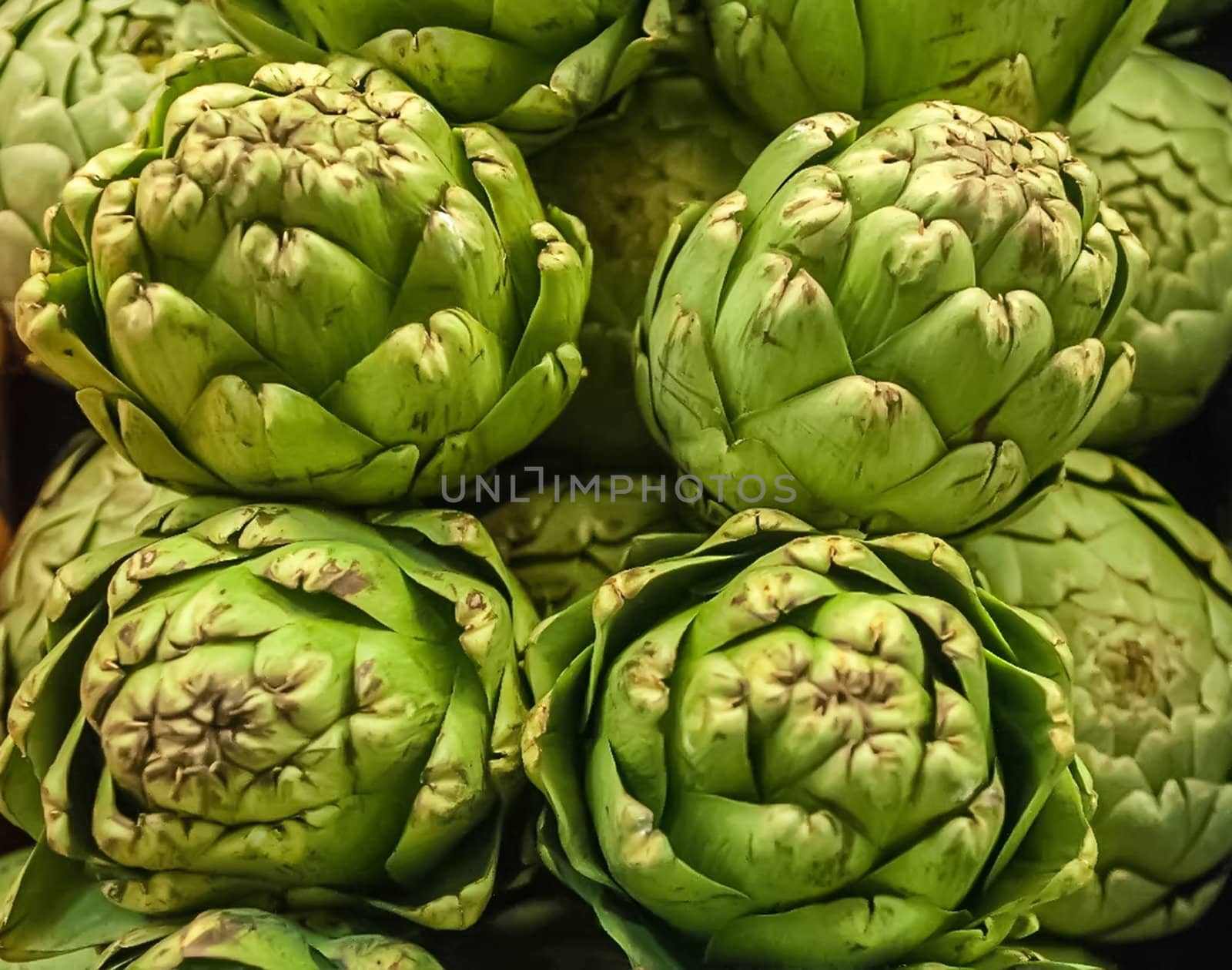 Pile of Artichoke on display at a farmers market by digidreamgrafix