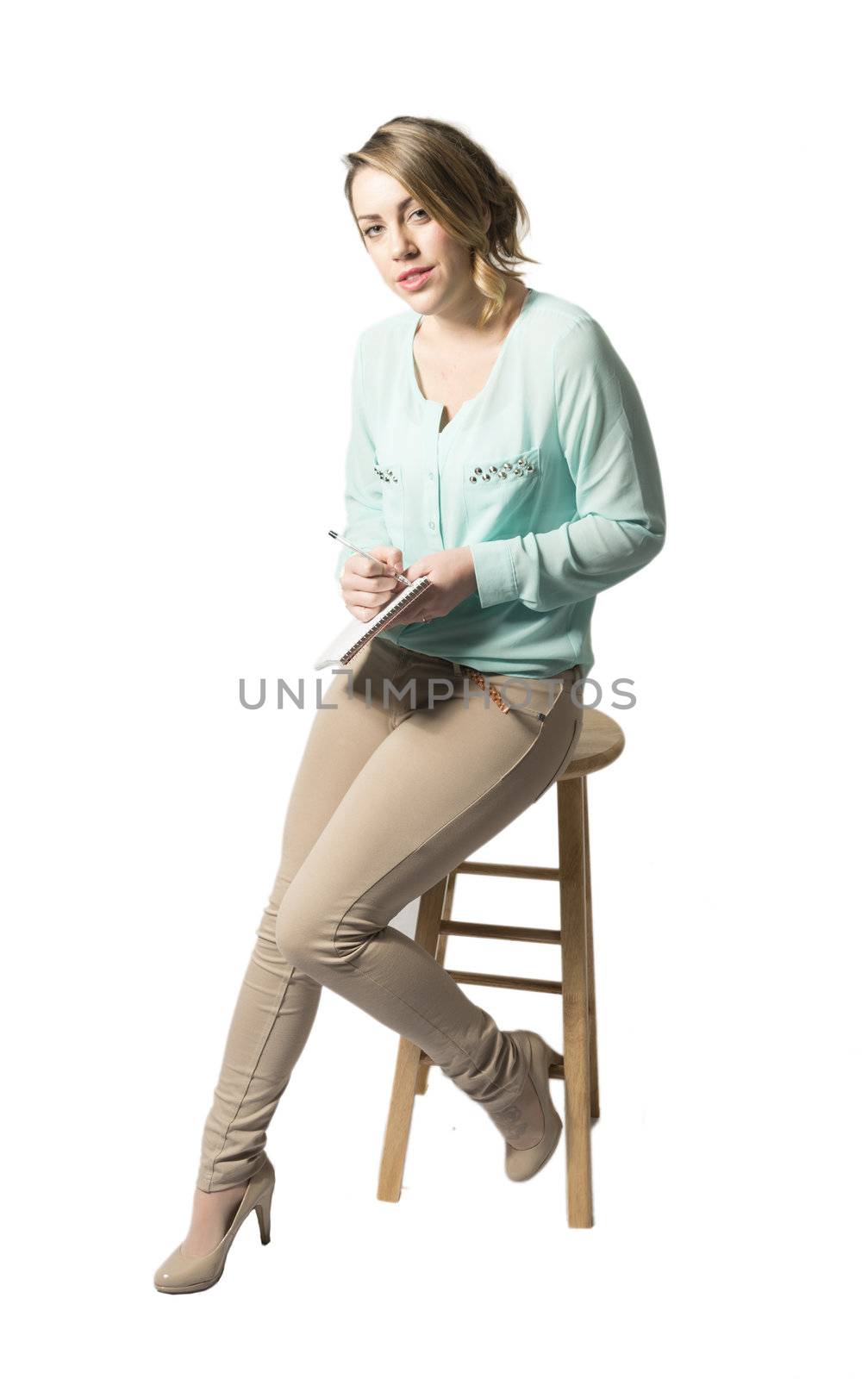 Business woman taking notes sitting on stool. Isolated on white background