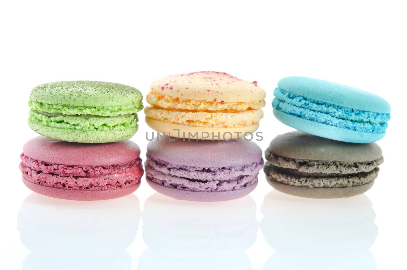 Colorful macaroon stack  on white background with reflection