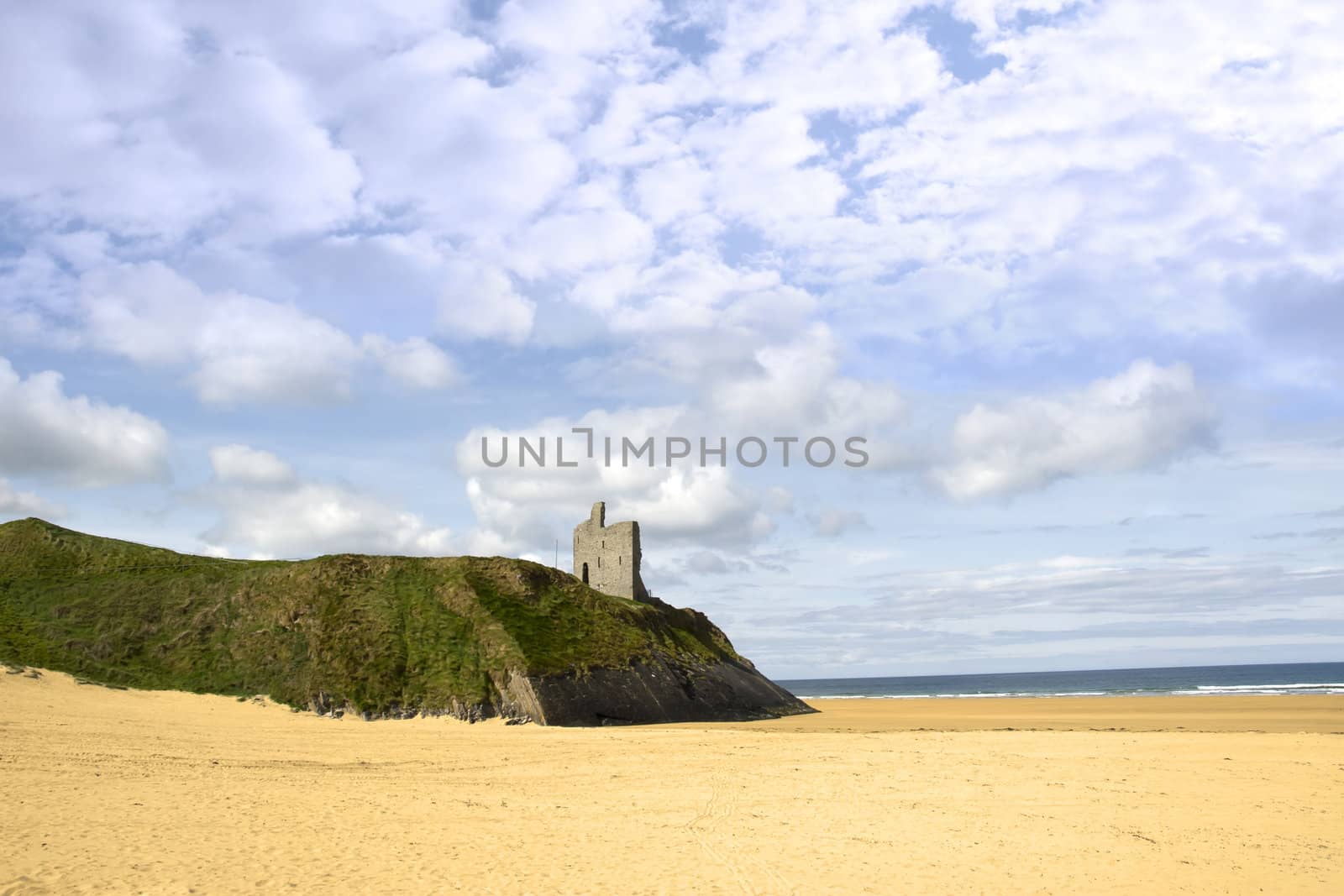 Ballybunion castle on the edge of a cliff overhanging a beautiful beach in county Kerry Ireland