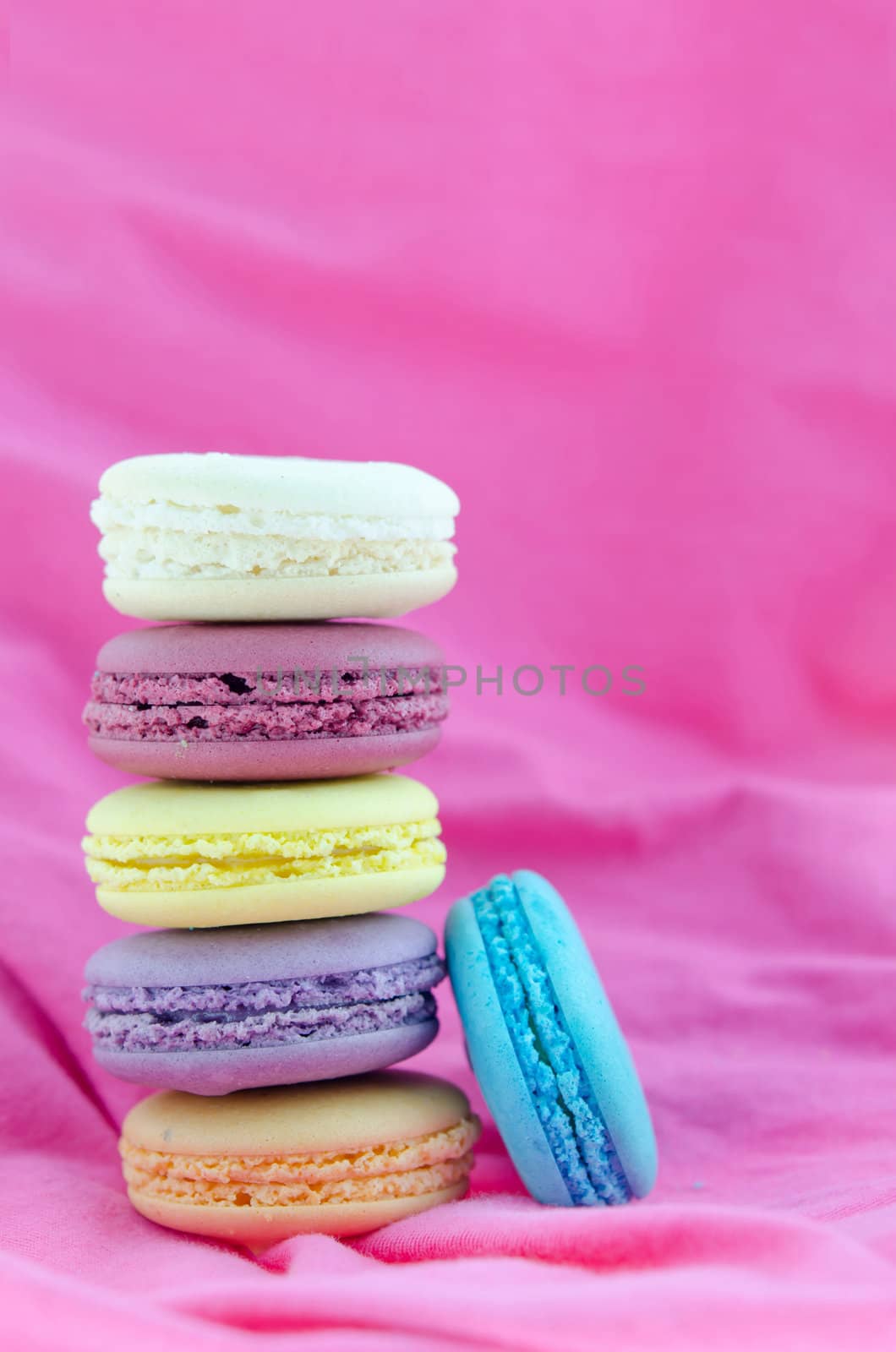   french macaroons  stack on  pink fabric background