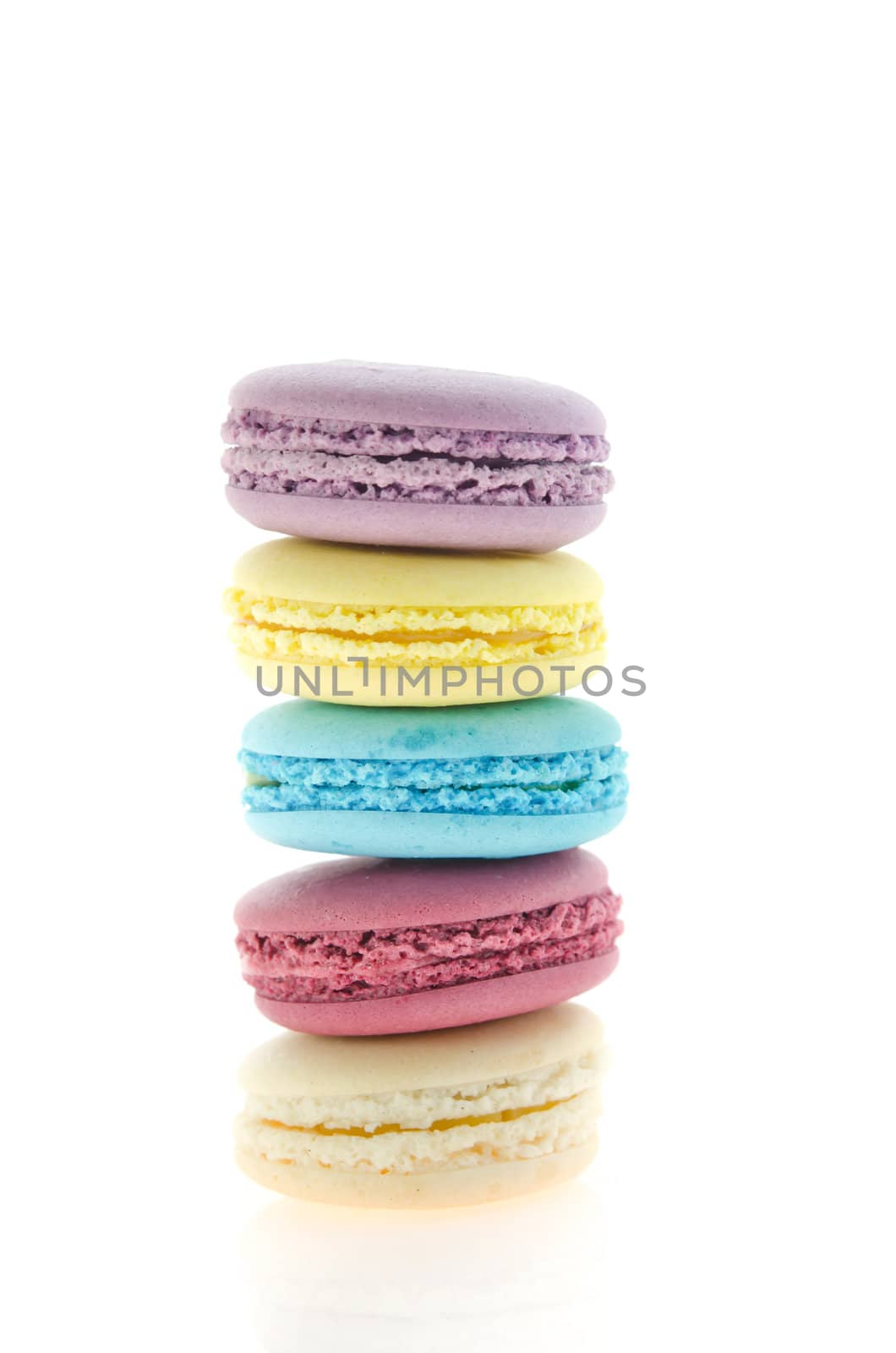 five  french macaroons  stack on  white background