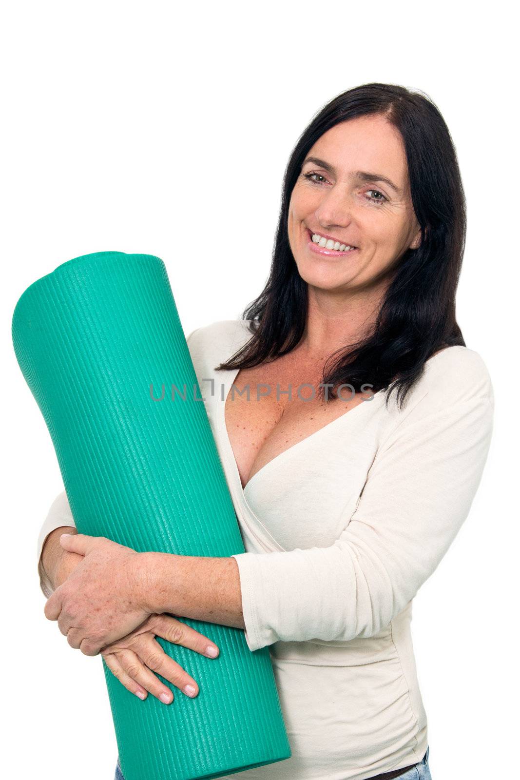 Dark haired Woman with an exercise matt in front of isolated background