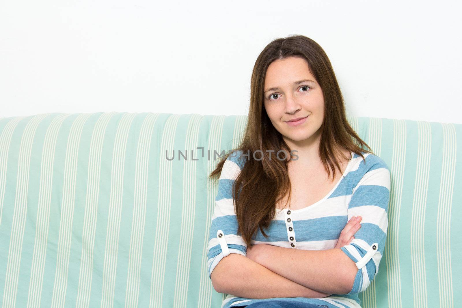 Young Brunette Teenager with arms crossed looking at camera