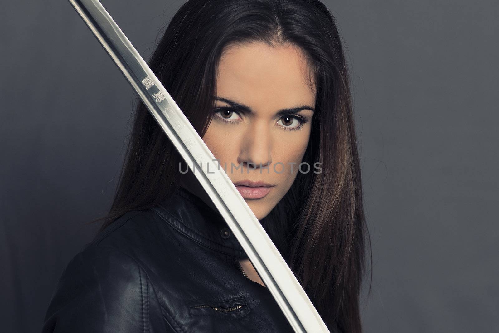 Portrait of beautiful girl with Katana in studio