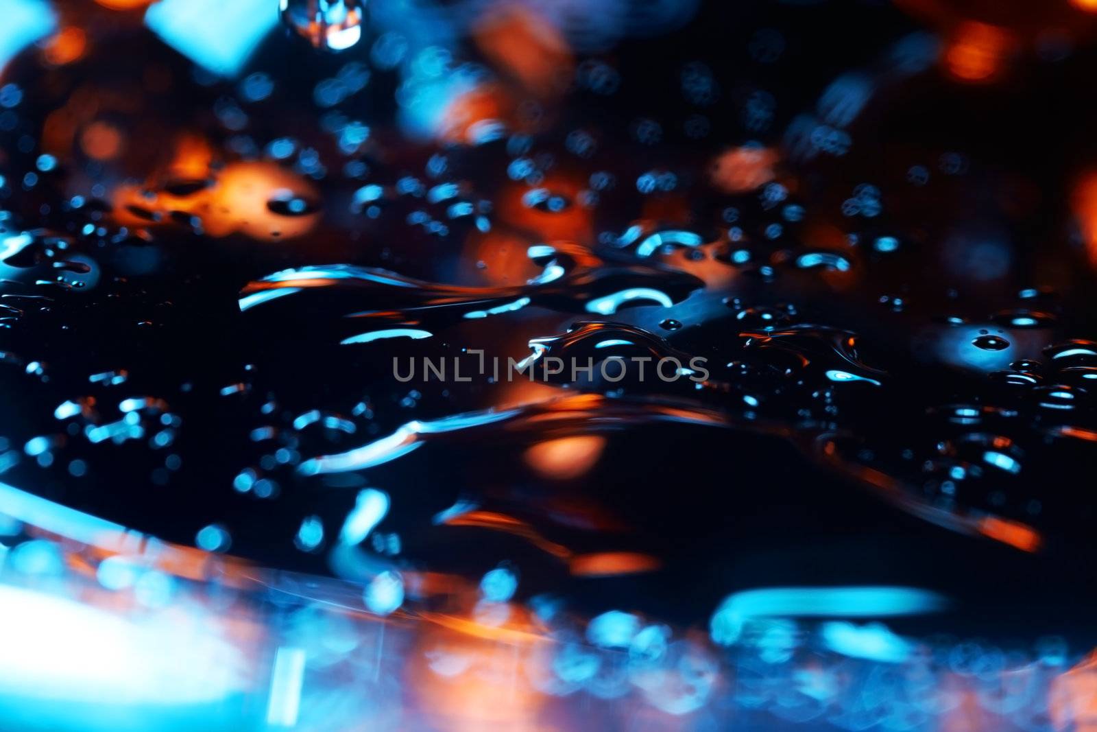 Abstract close-up photo of the colorful liquid surface