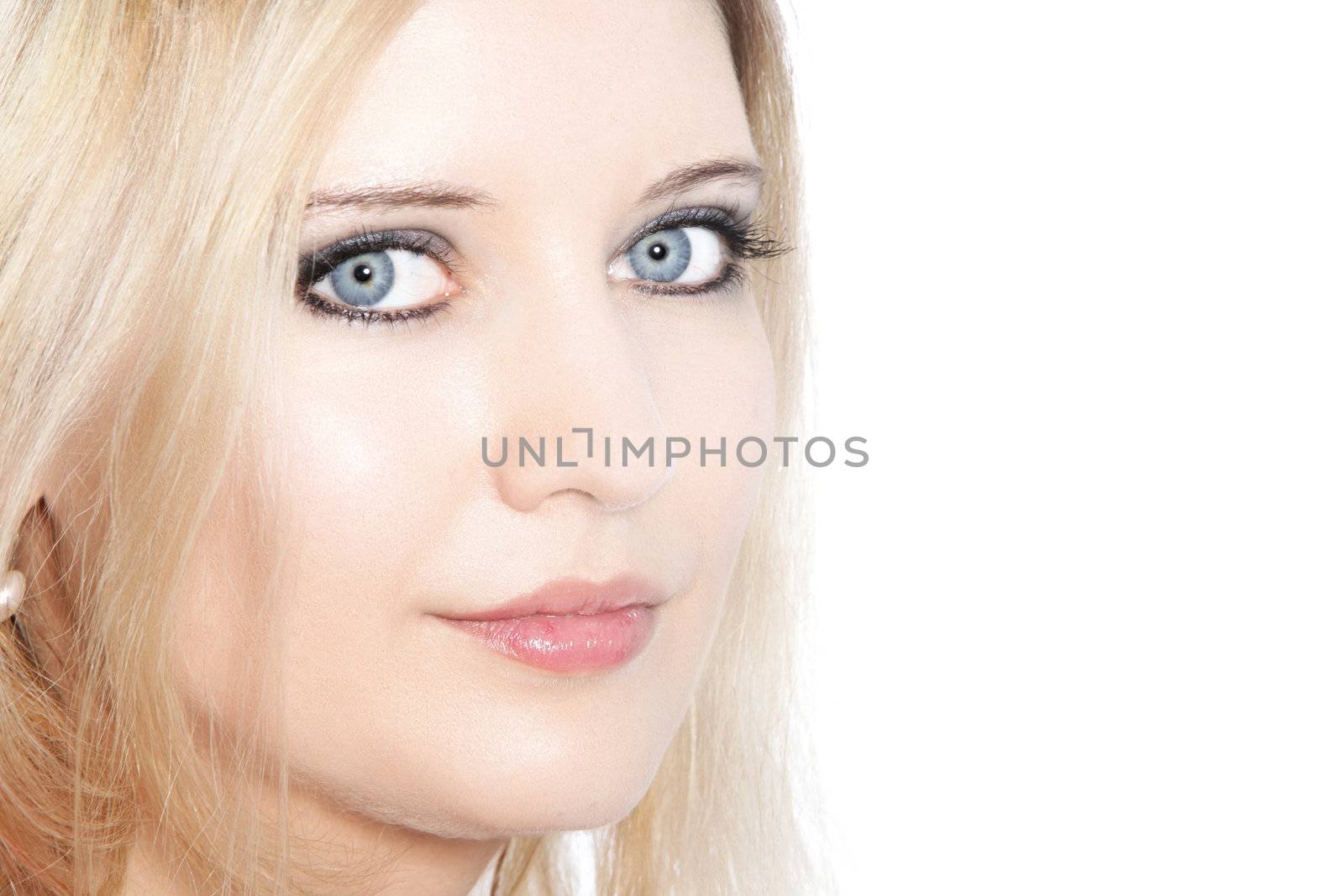 Close up of a beautiful blond haired woman with pale blue eyes.