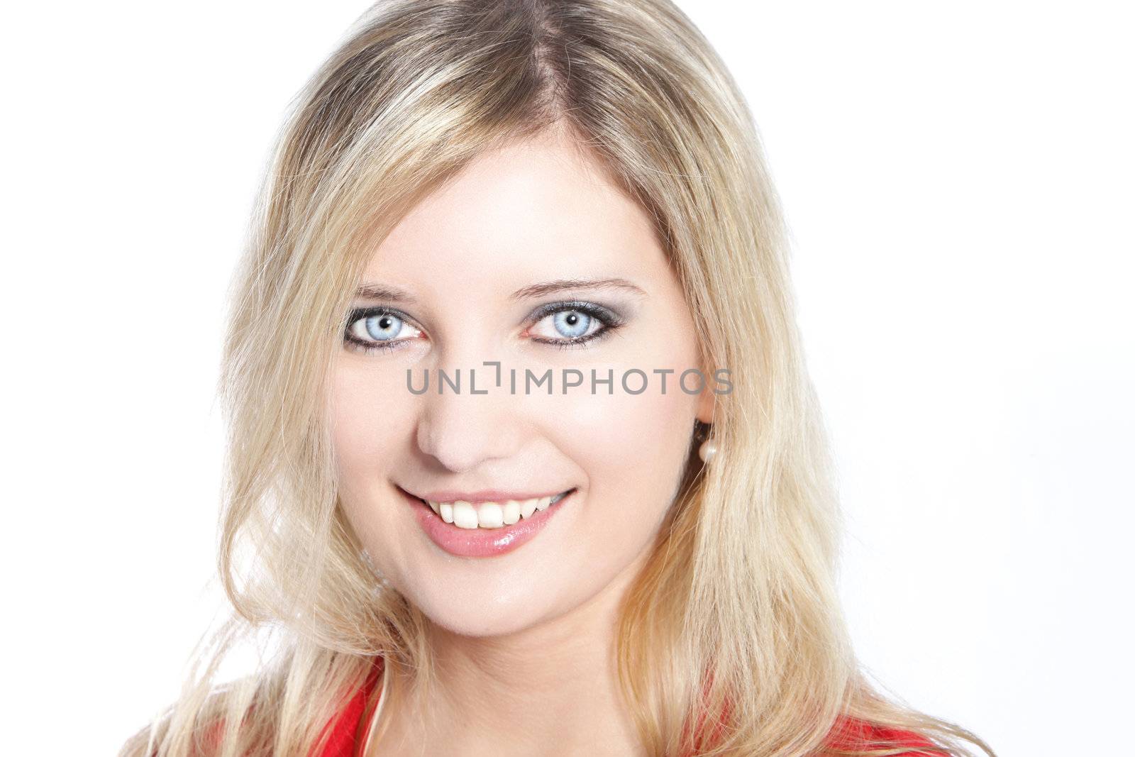 Portrait of a beautiful blond haired woman with pale blue eyes smiling at camera.