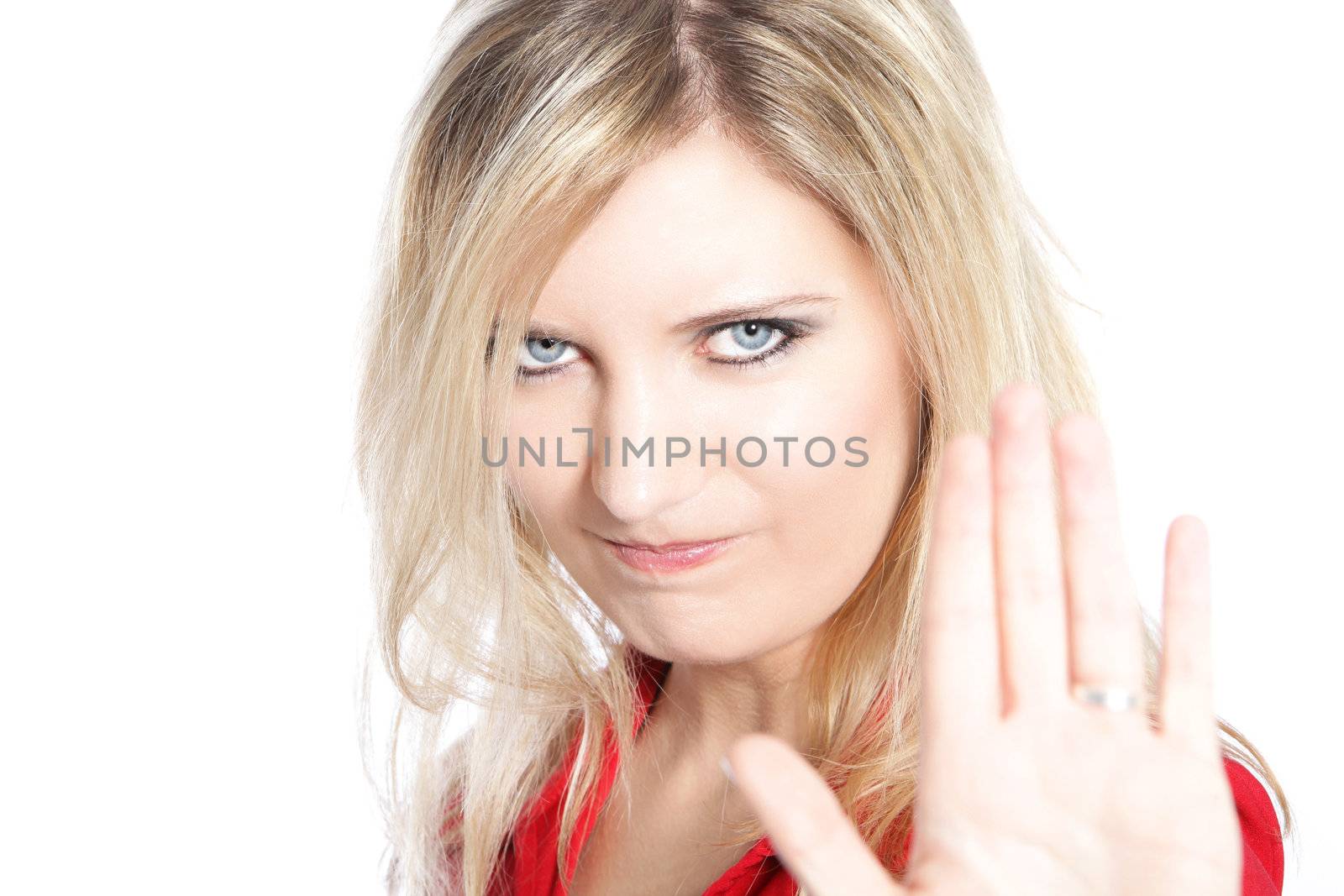 Woman making a Halt gesture raising the palm of her hand with a look of determination, head portrait on white