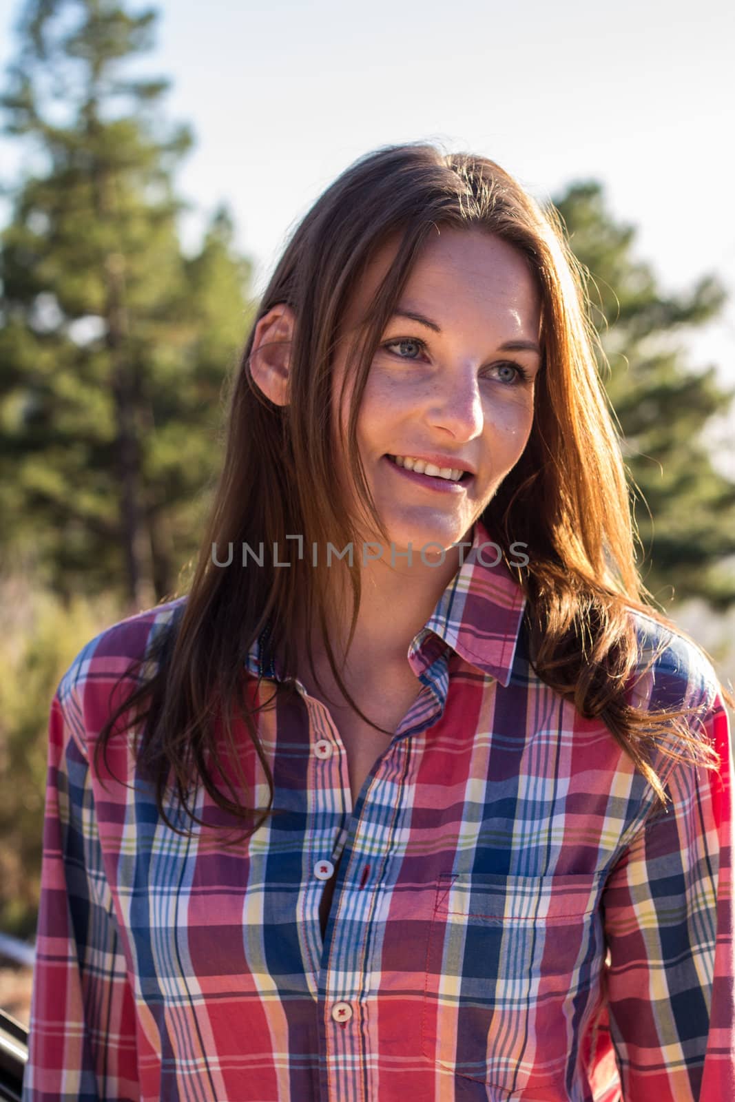 Brunette female model standing in the sun