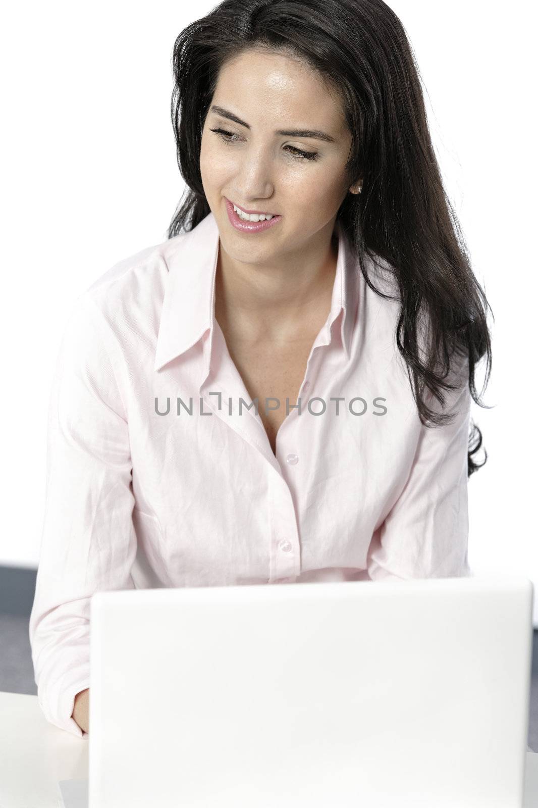 Beautiful young woman sat at white table with her laptop computer