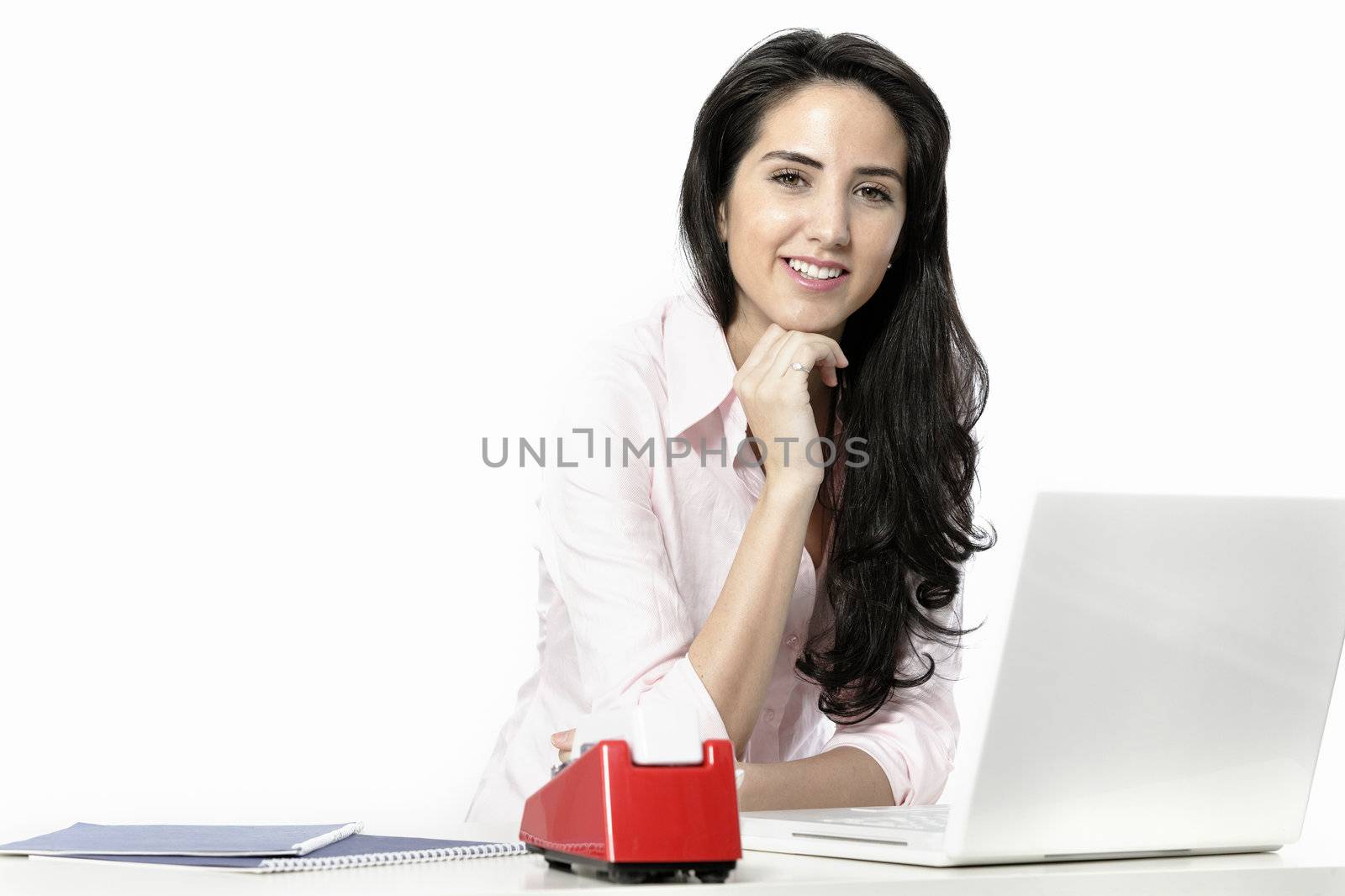 Beautiful young woman sat at white table with her laptop computer