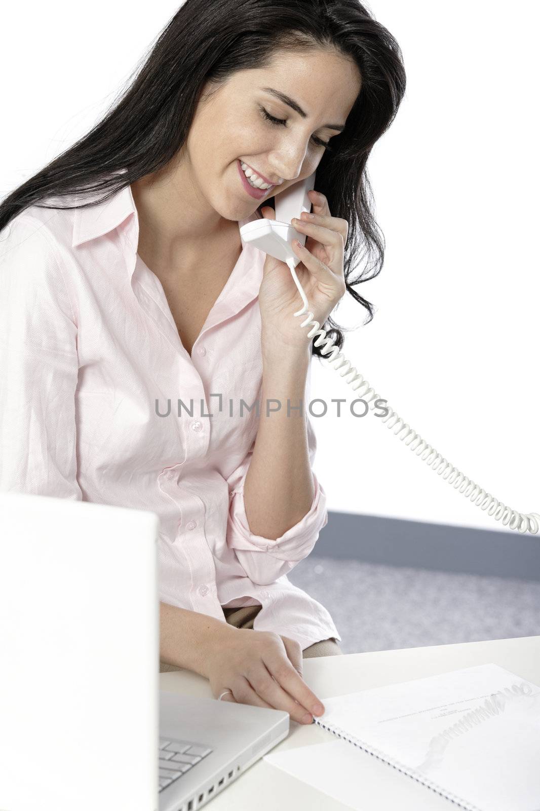 Beautiful young woman on a reception desk talking on the phone
