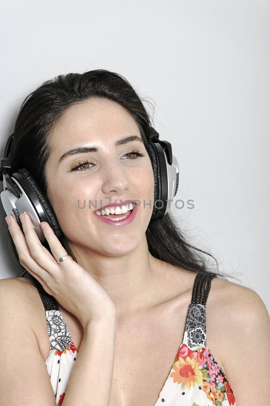 Attractive young woman using headphones to listen to music