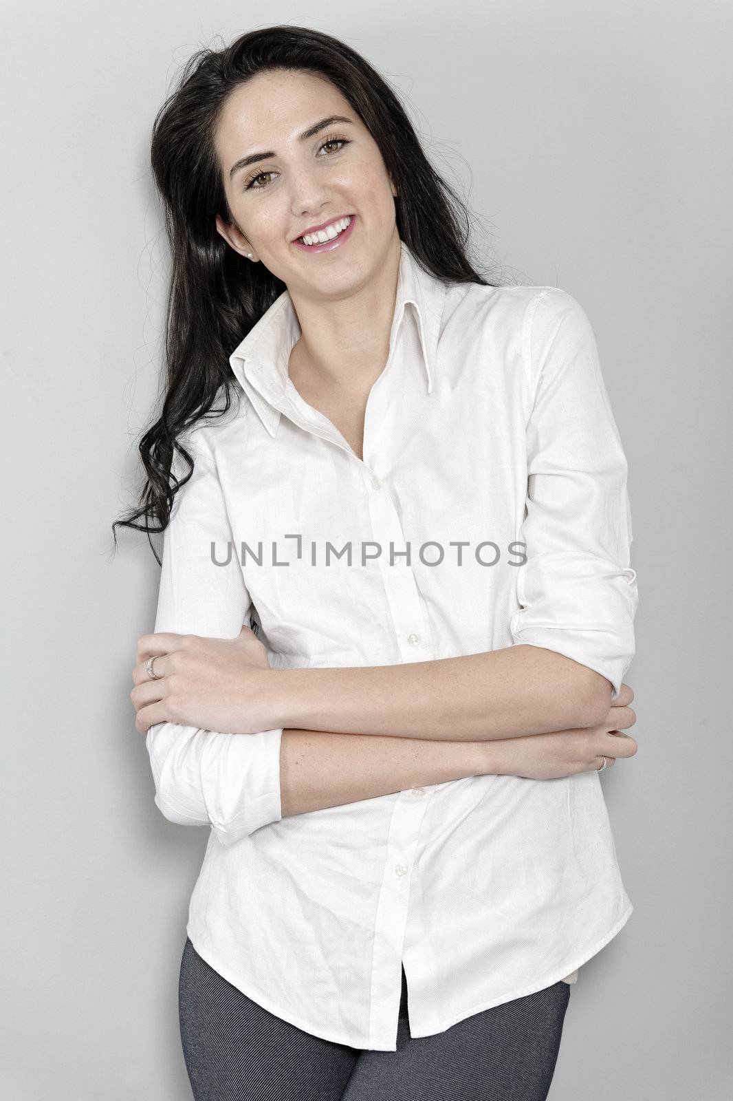 Attractive young woman in white shirt smiling and laughing