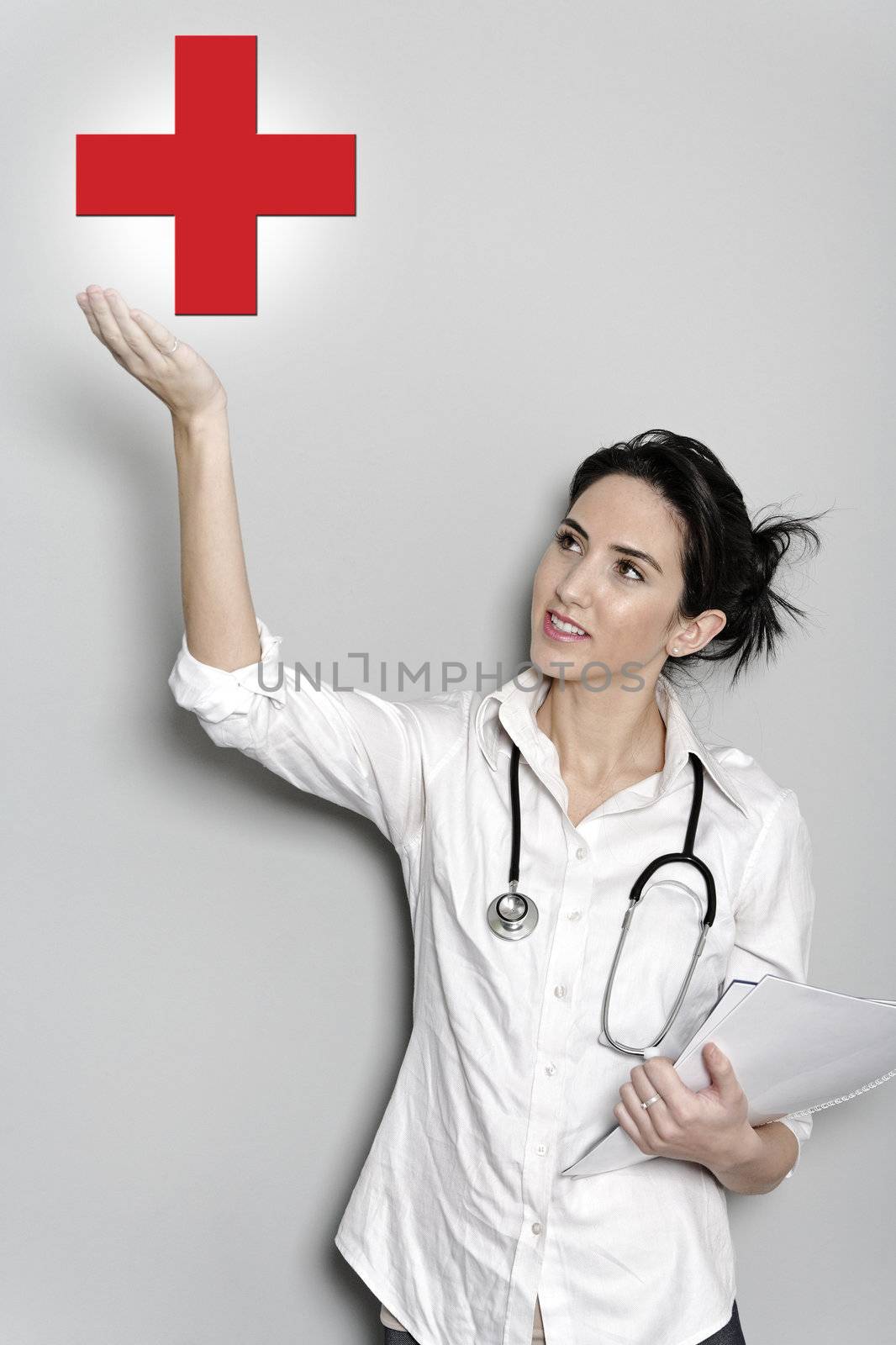 female doctor holding a red cross by studiofi