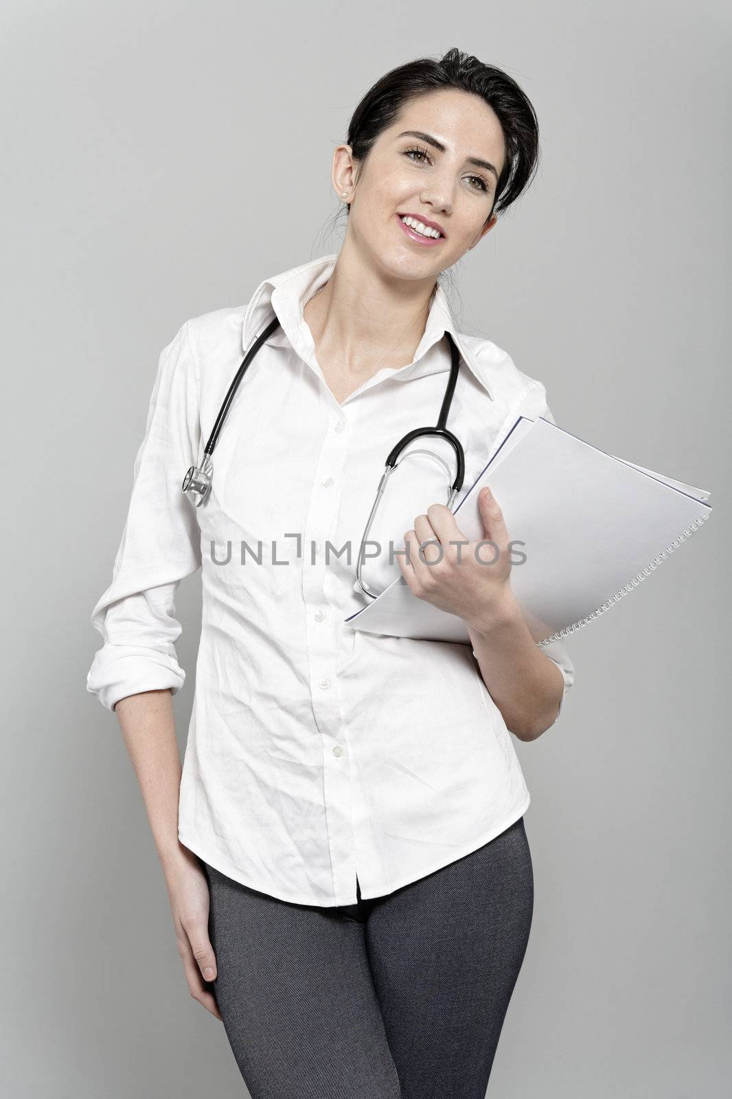 Beautiful young doctor standing with stethoscope