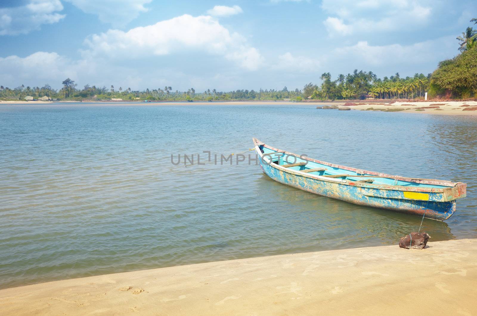 Small fish boat at the tropical coast. Outdoors photo with vibrant colors
