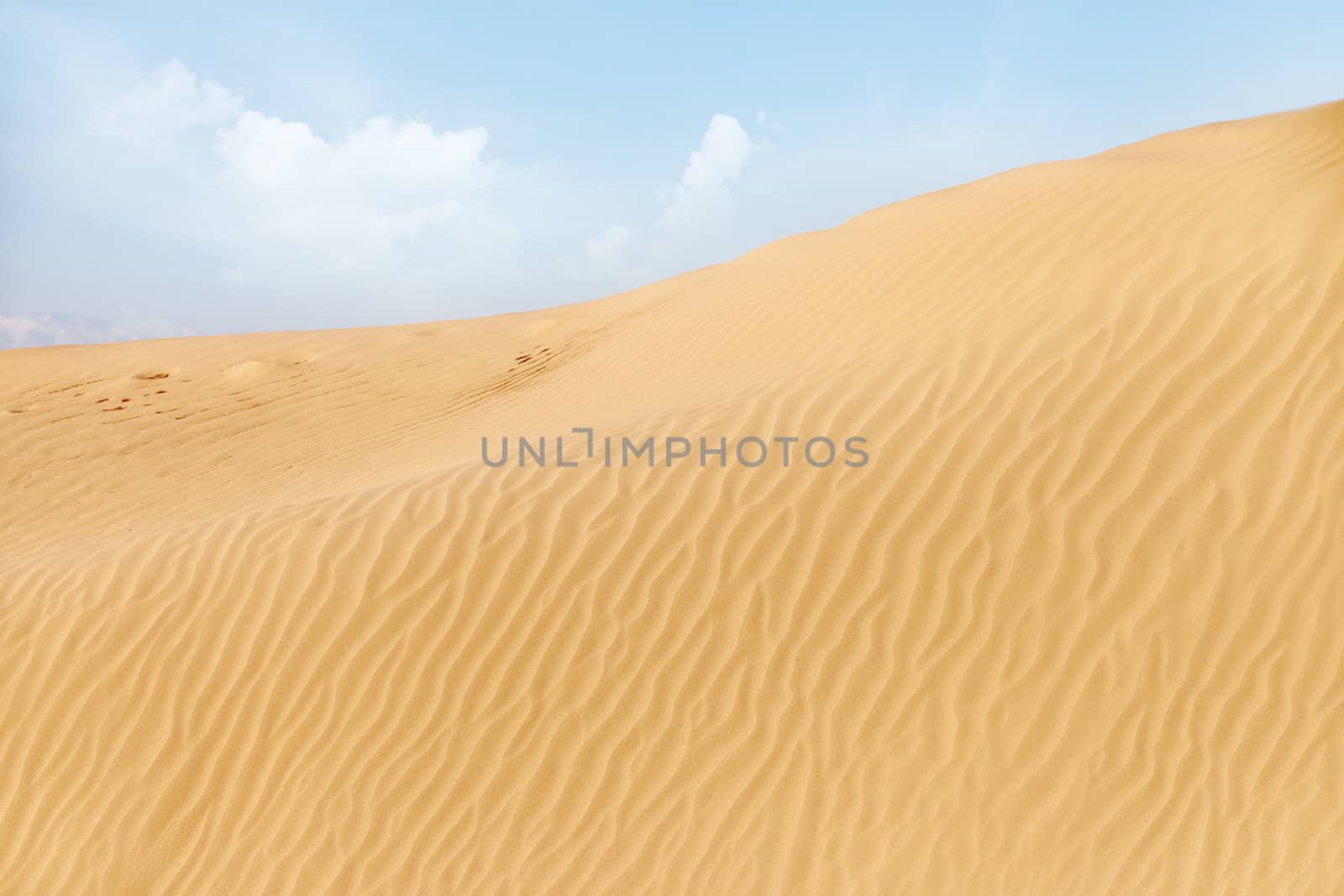 View on the rippled sand dunes in the desert. Natural light and colors