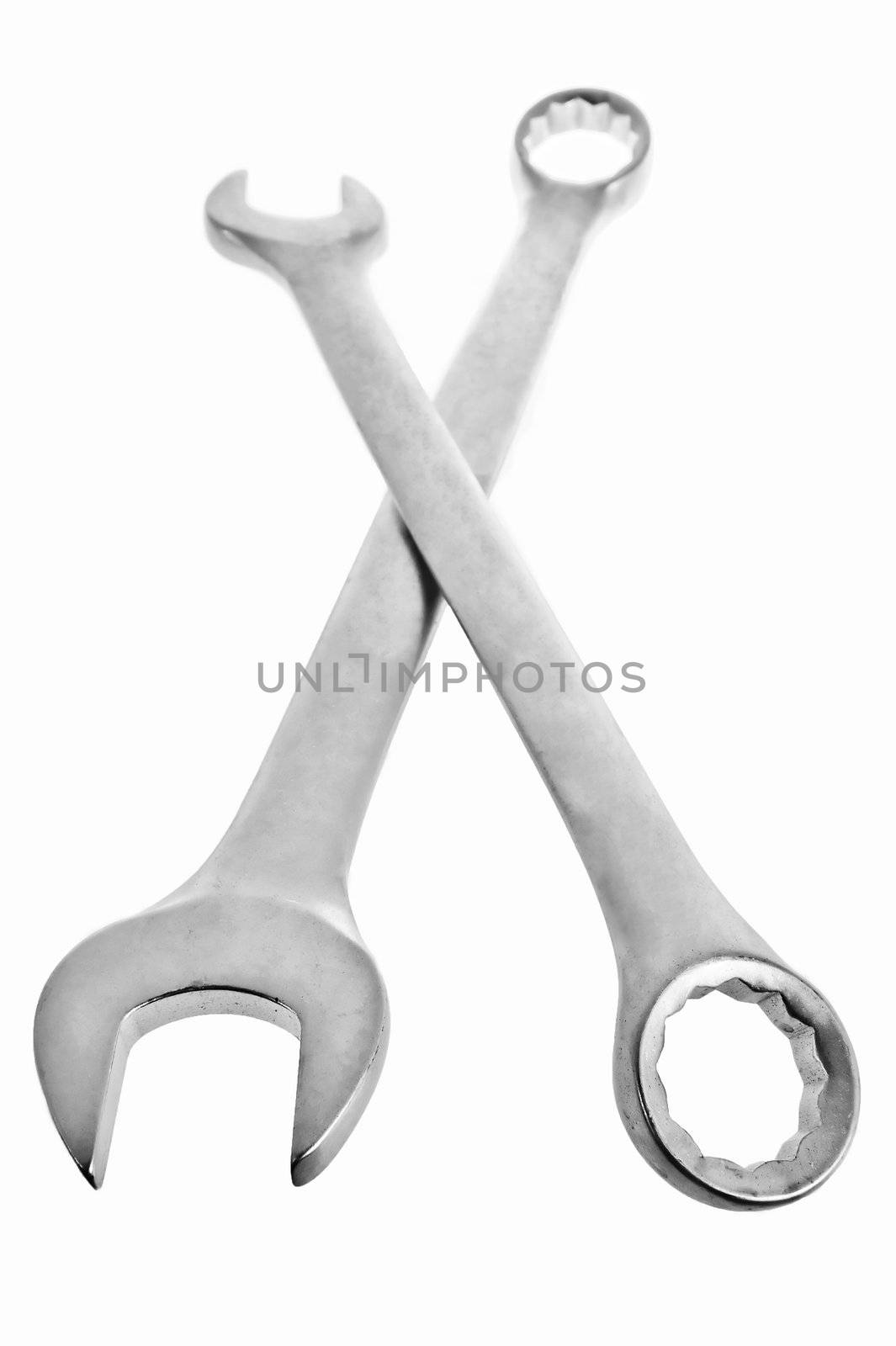 Two crossed wrenches on a white lie by kosmsos111