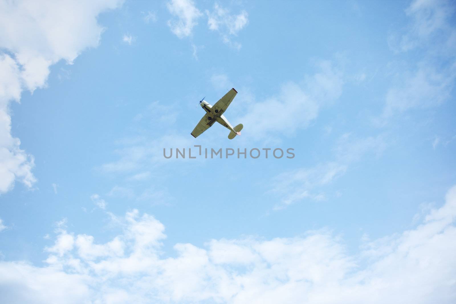 Airplane flies in the cloudy sky. Natural light and colors