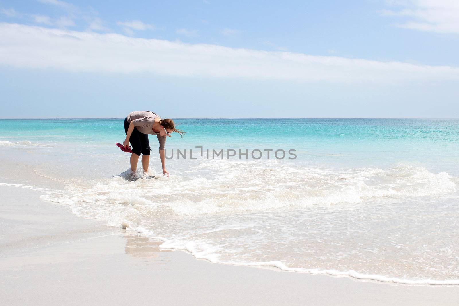 Woman standing in Water at the Beach of Kommetjie