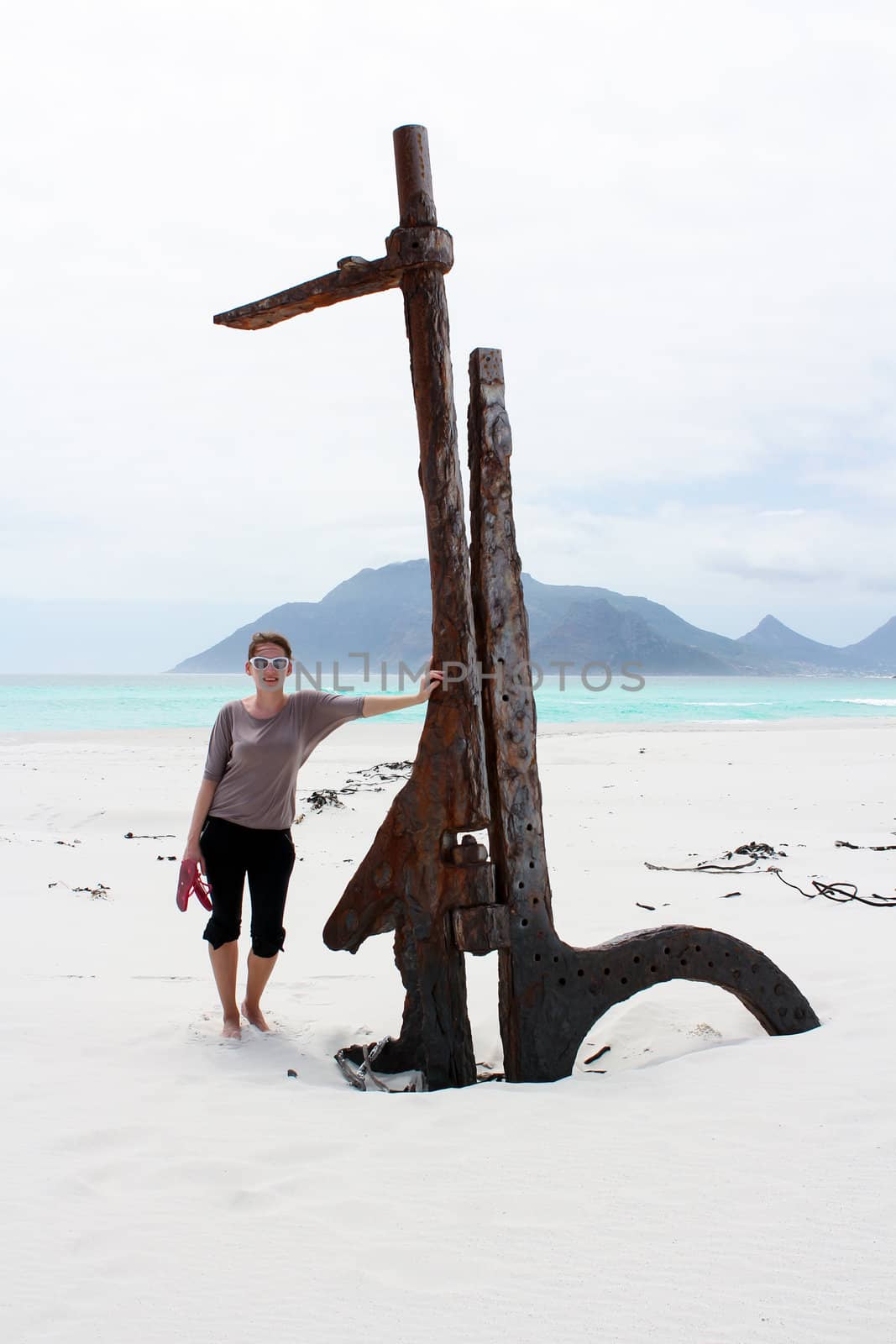Woman standing at Shipwreck Kakapo at the beach of kommetjie by dwaschnig_photo
