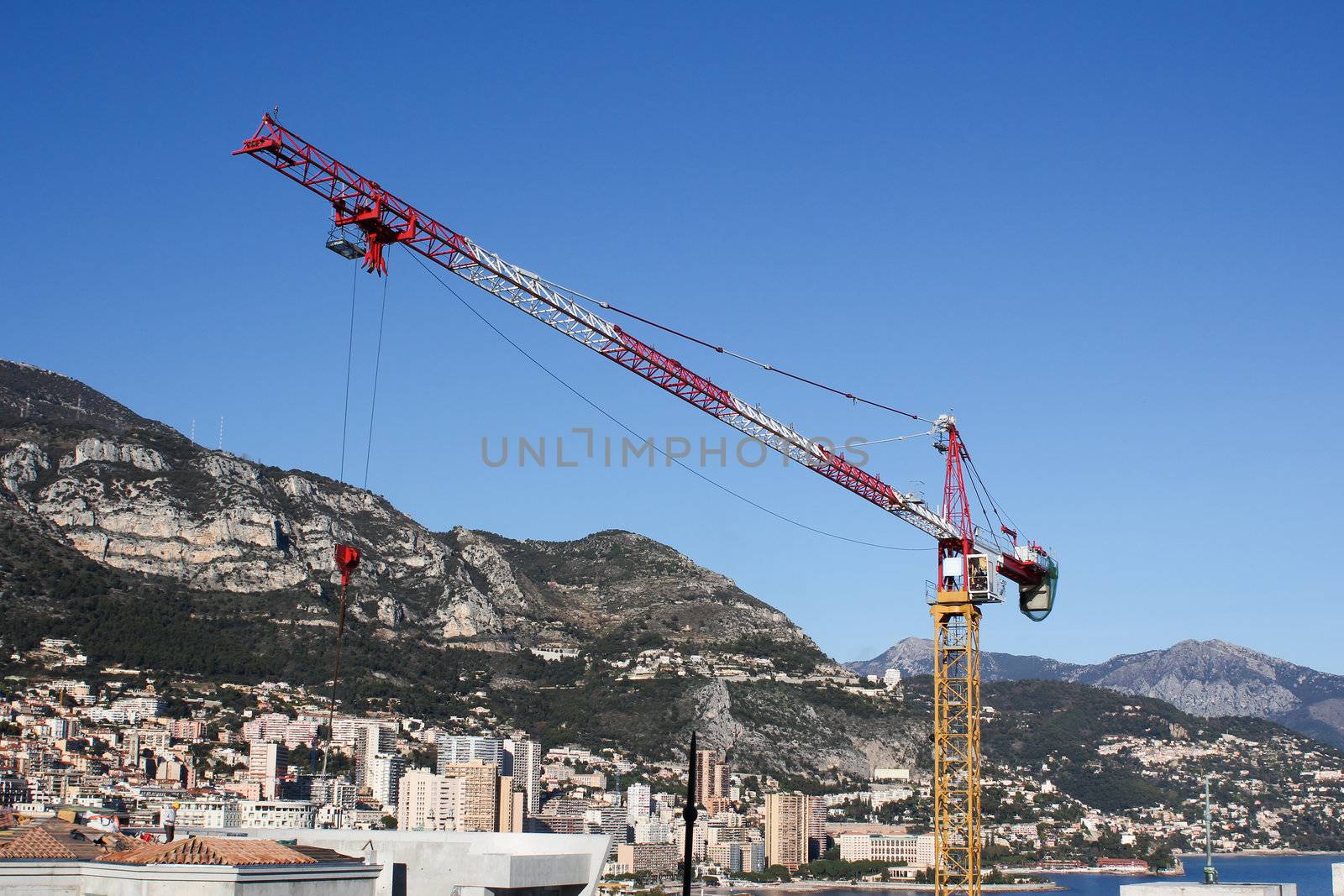 Yellow Crane with city in the background by dwaschnig_photo