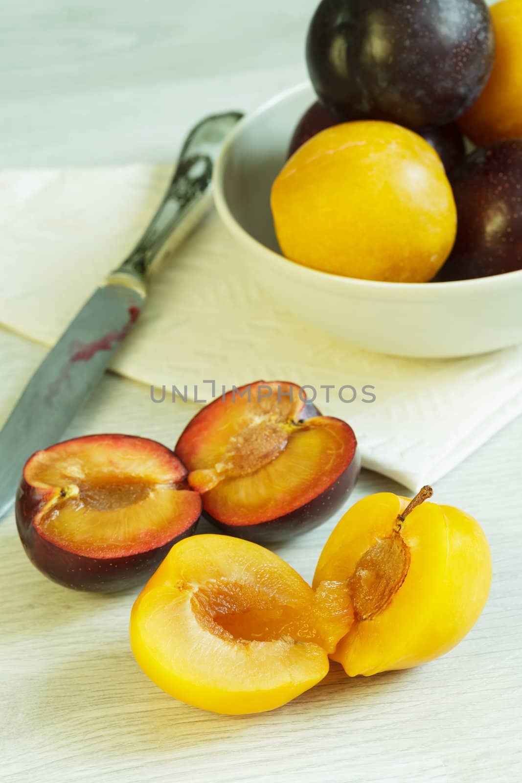 Two cuted different varieties of ripe plums