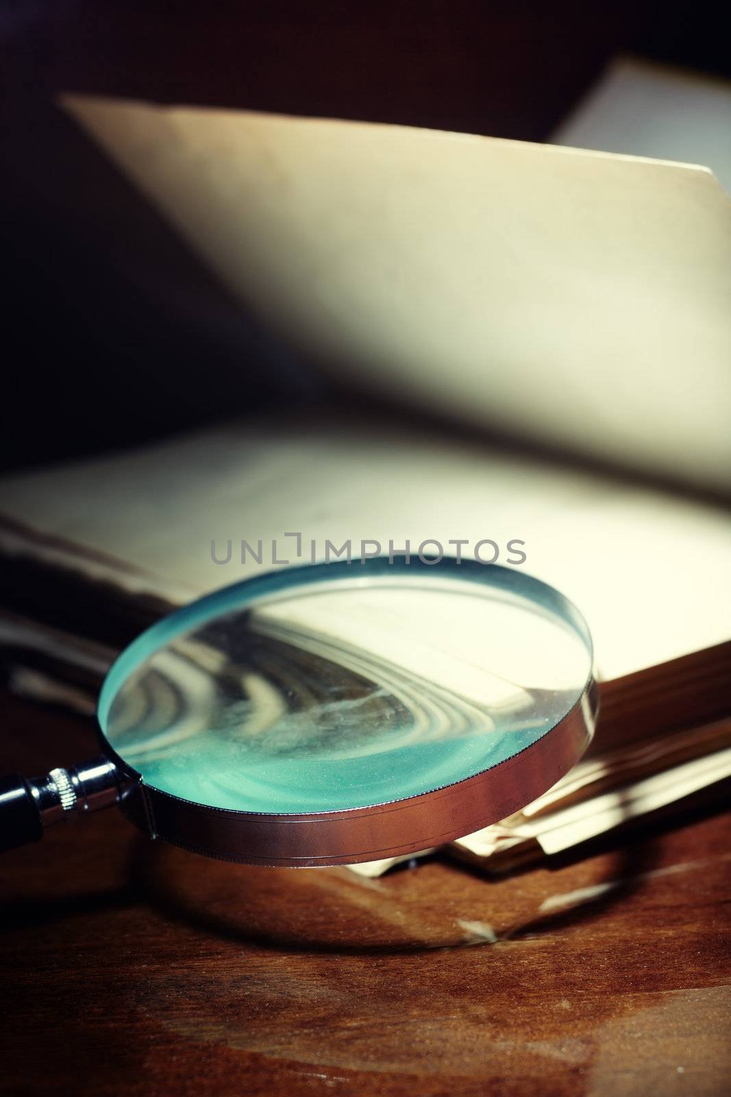 Old book and magnifier by Novic