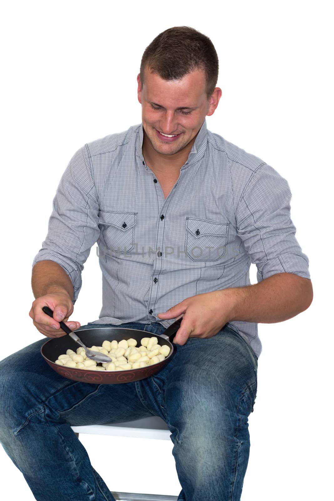 Young Attractive Man Cooking gnocchi in A Pan