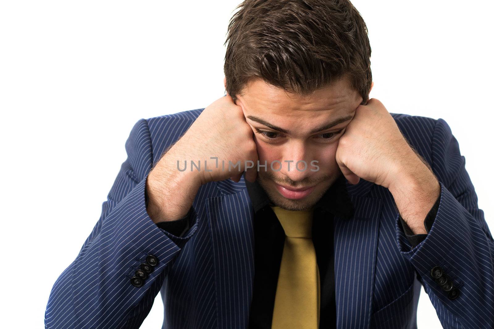 Young stressed overwhelmed businessman wearing a suit and golden tie