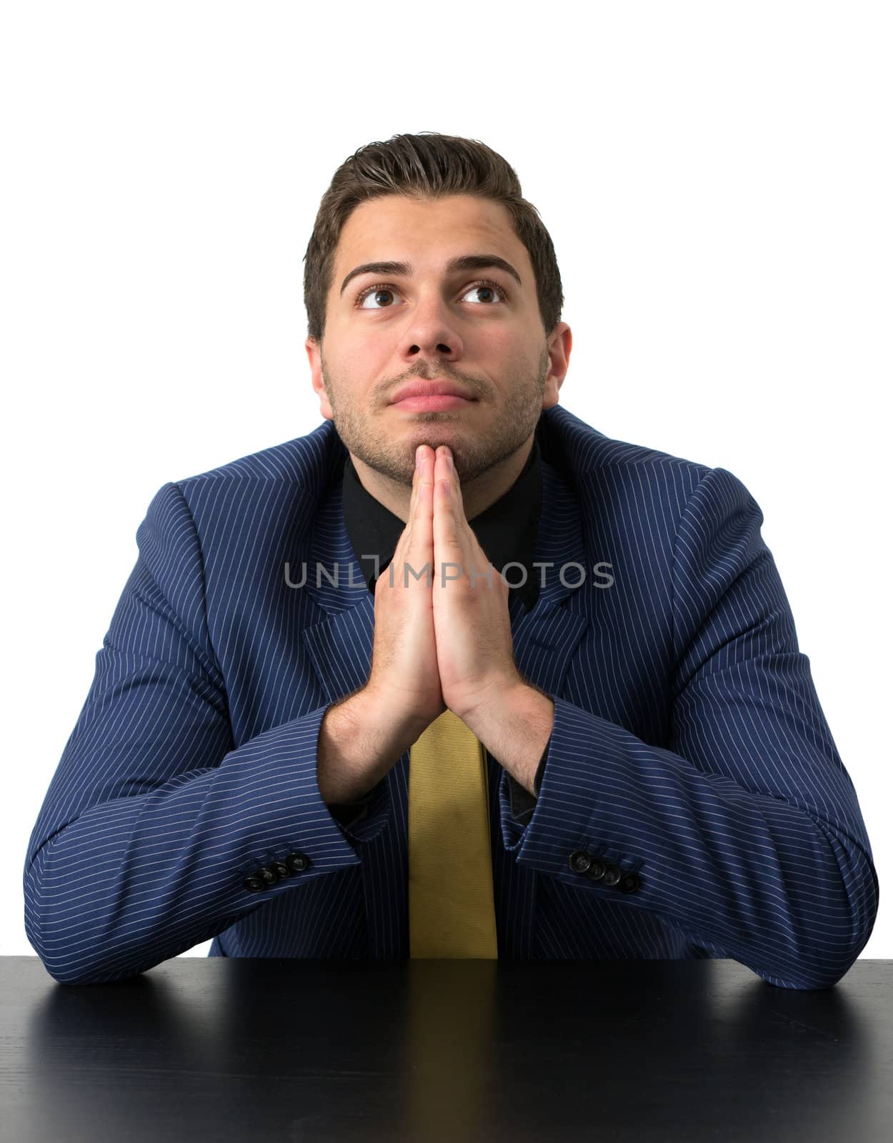 Young Businessman in a blue suit with a golden tie looking up fully thoughtful