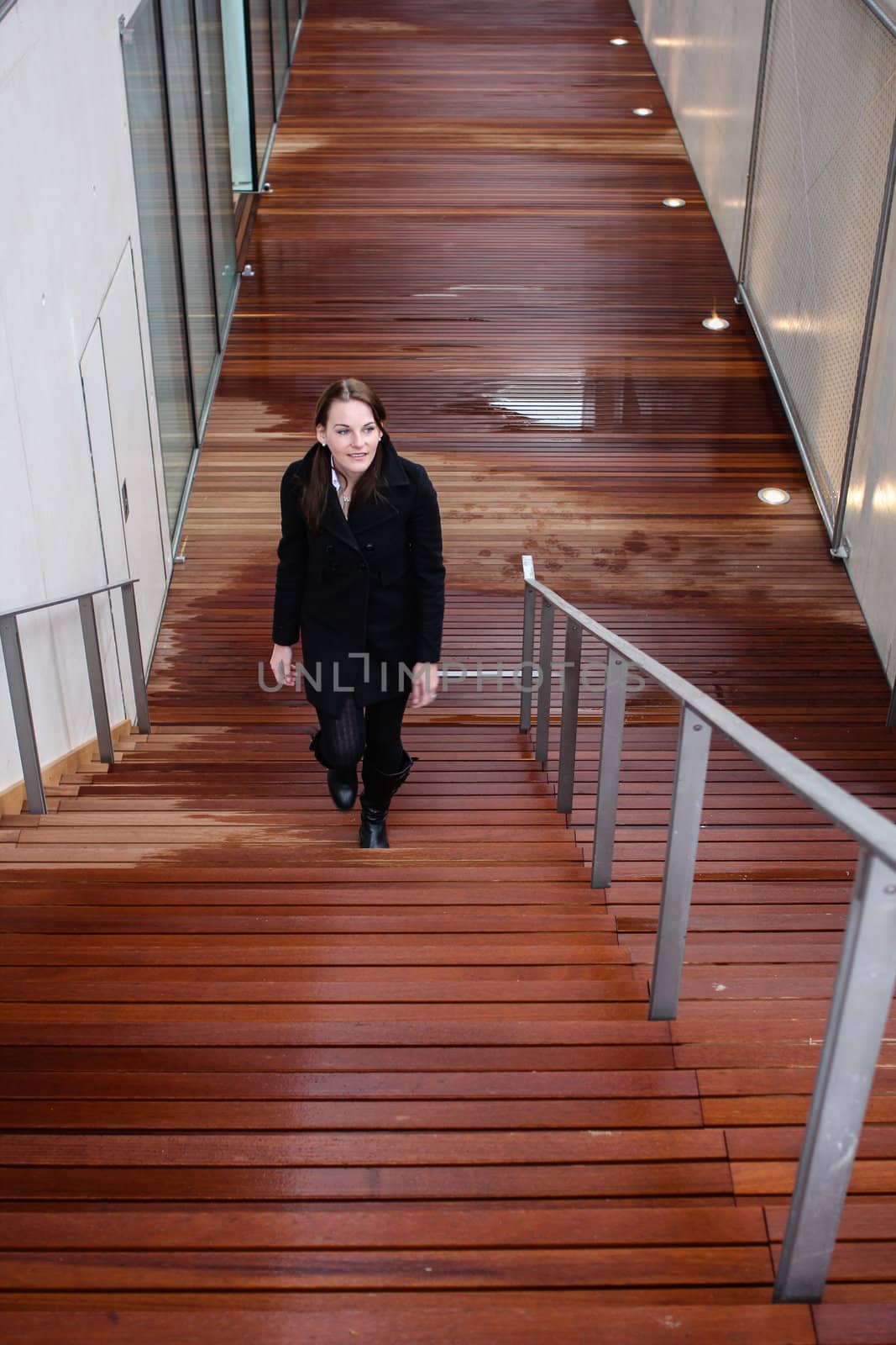 Brunette Woman Walking Up Stairs by dwaschnig_photo