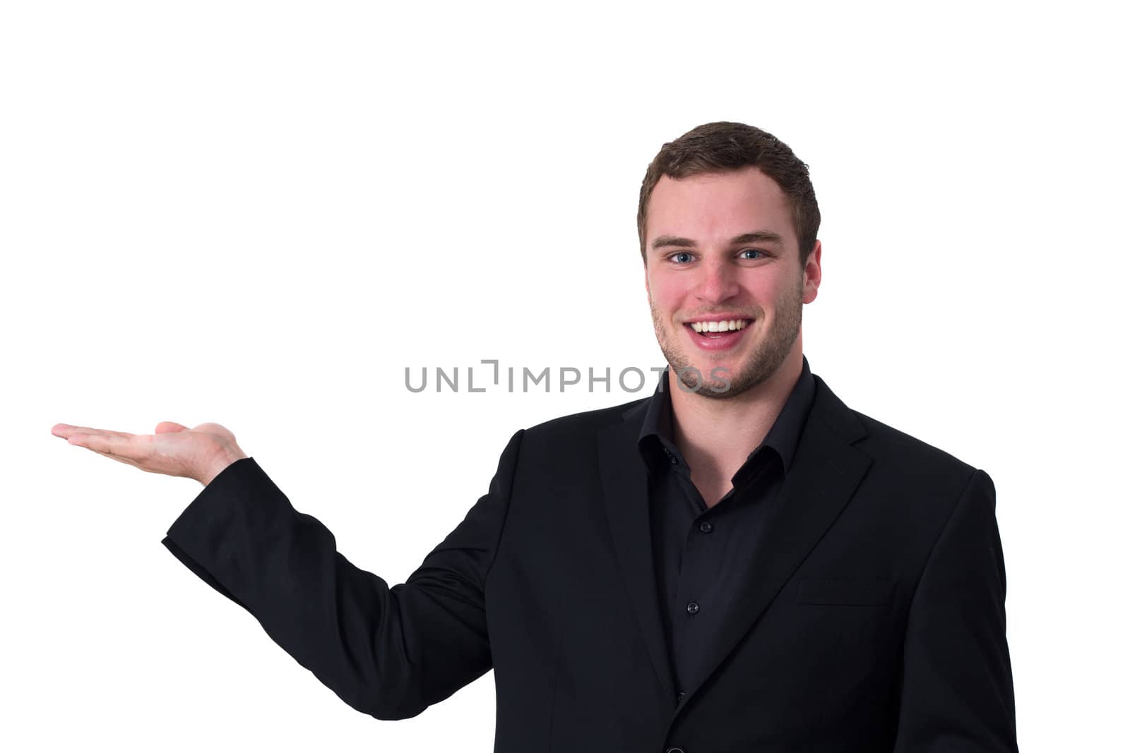 Man showing and advertising isolated space while smiling sympathetic