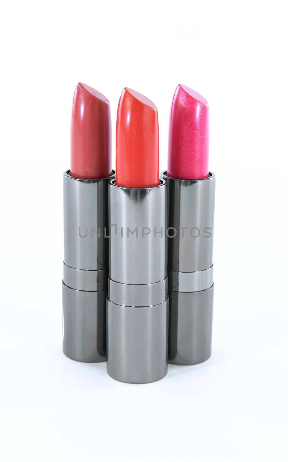 Three lipstick containers without their lids isolated on a white background