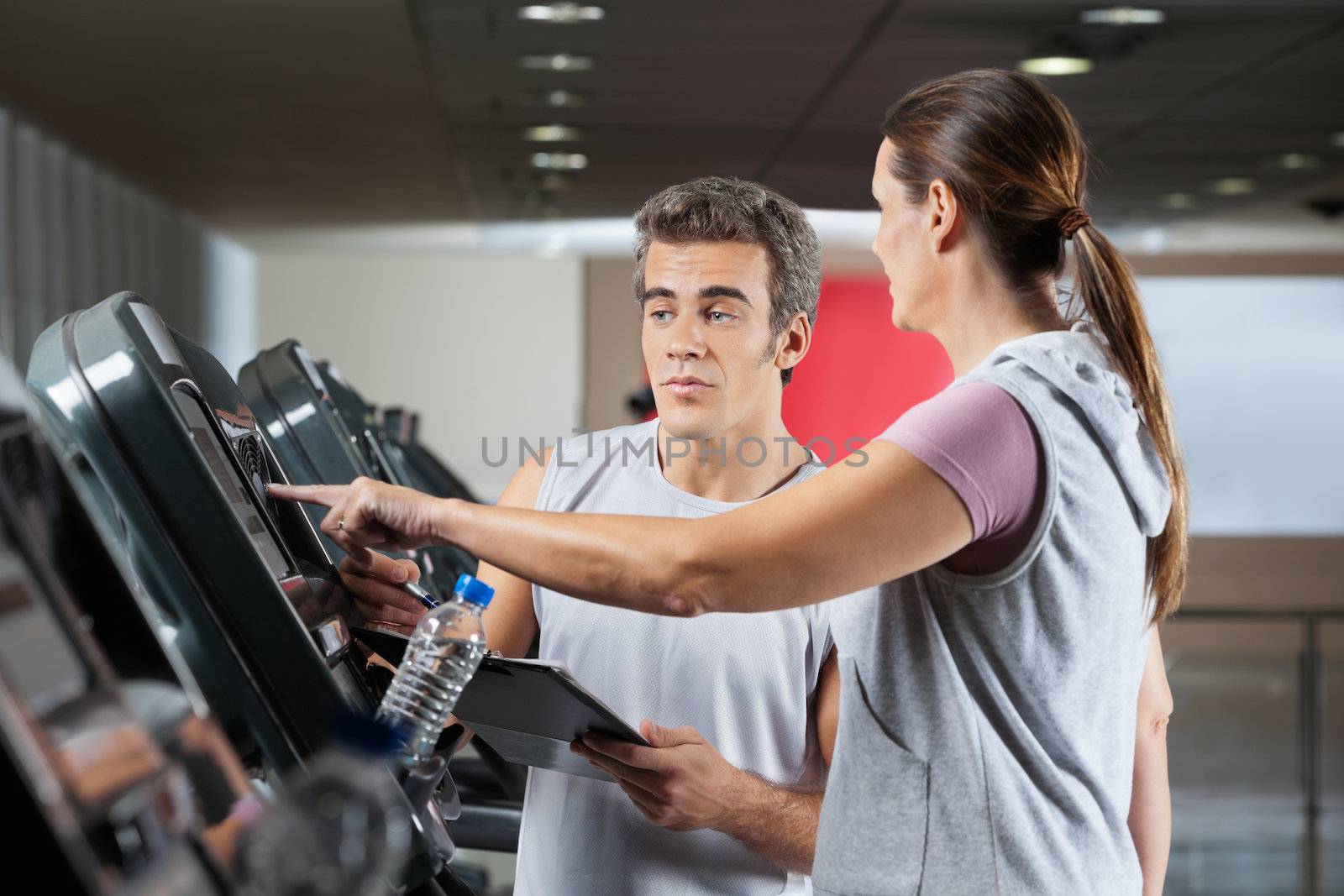 Woman Asking About Machines In Gym by leaf