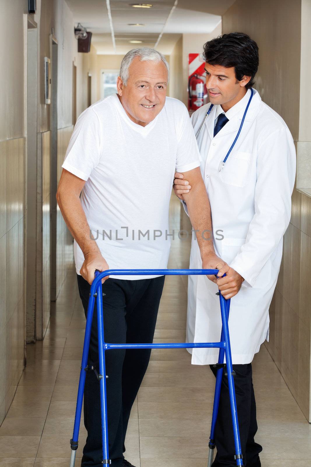 Doctor Assisting Old Man On a Walker by leaf