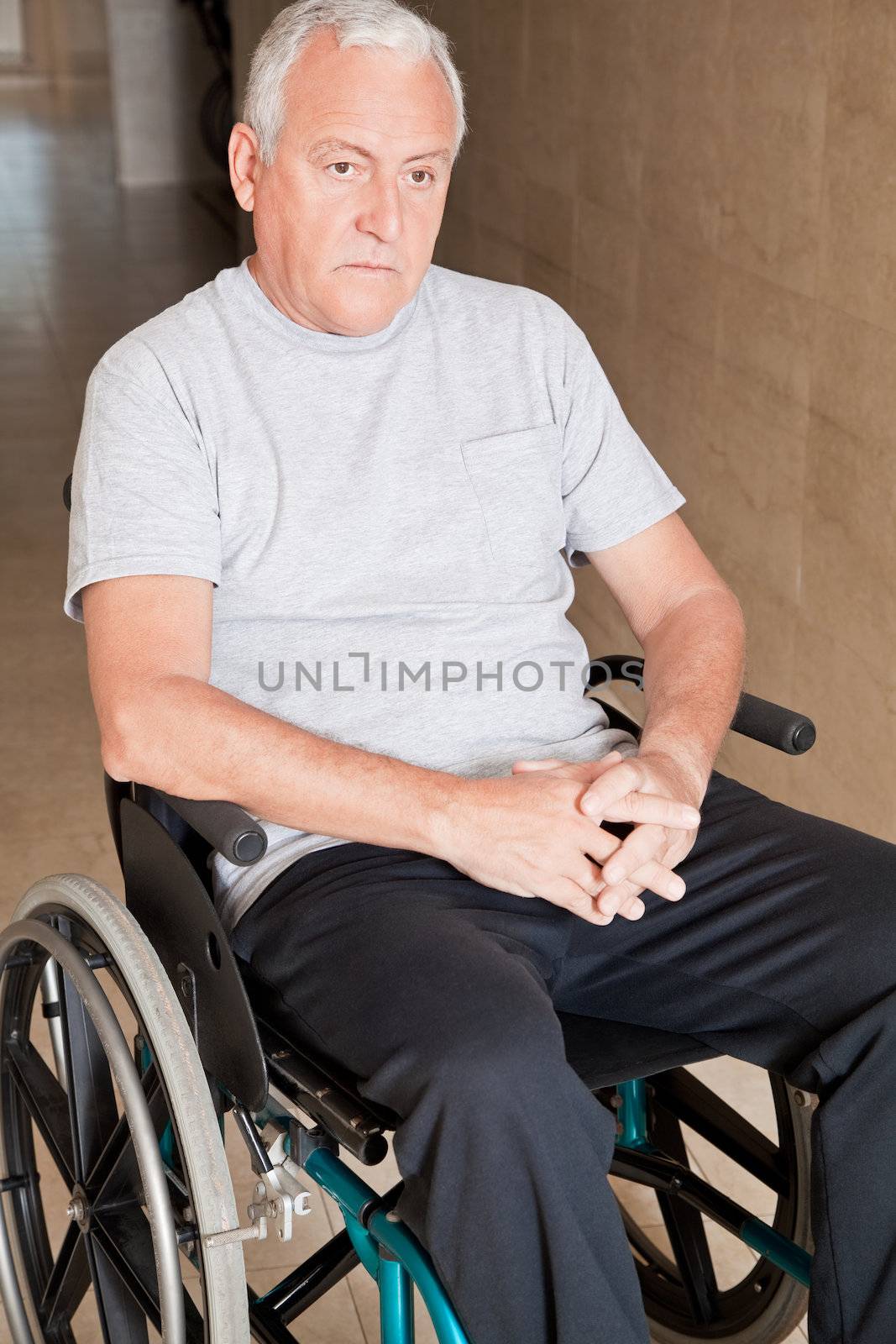 Retired man on wheelchair at hospital.