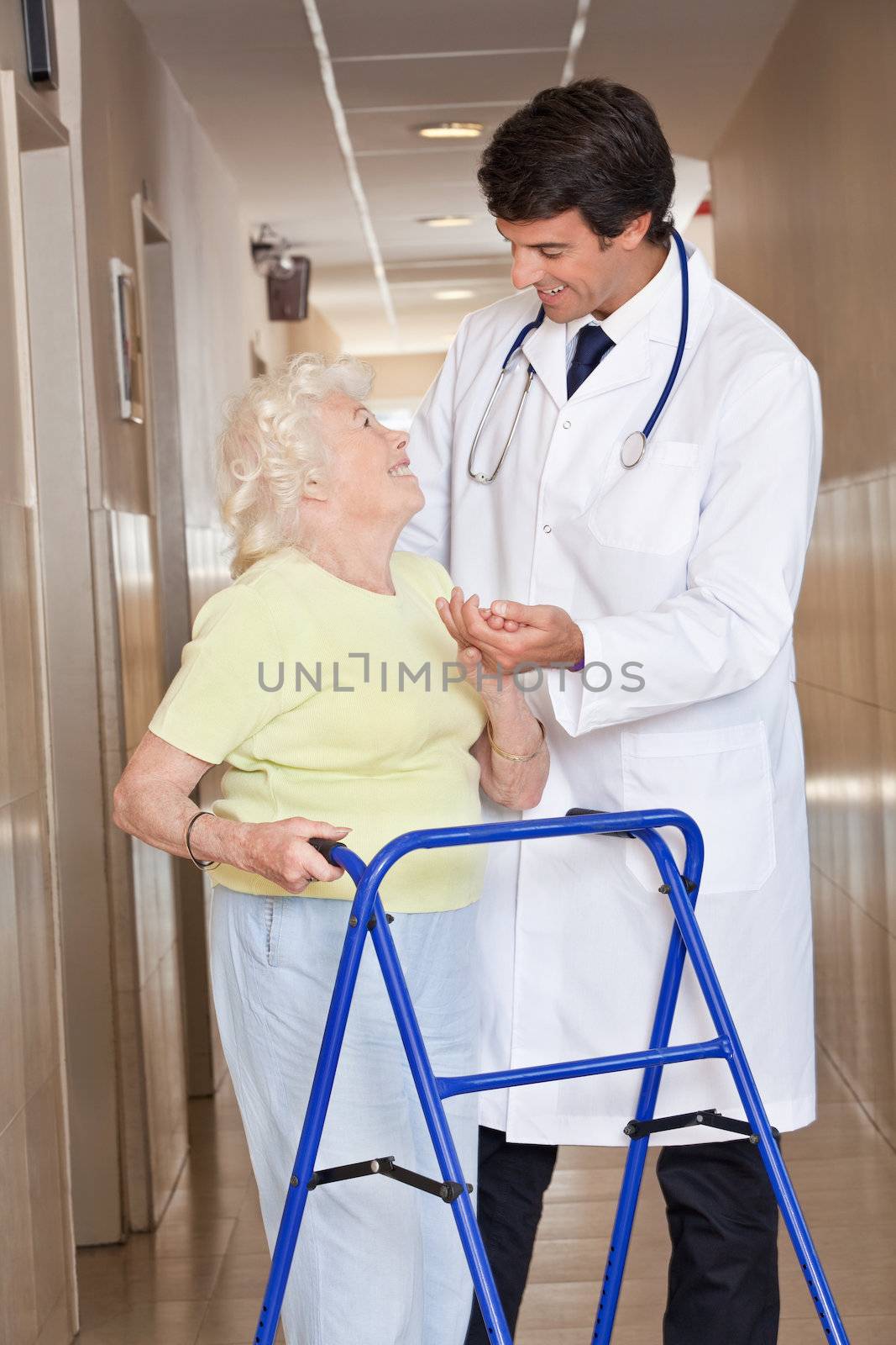 Portrait of elderly woman and doctor with zimmerframe.